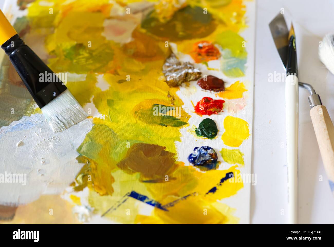 the artist mixes different colors with paintbrush to paint a picture