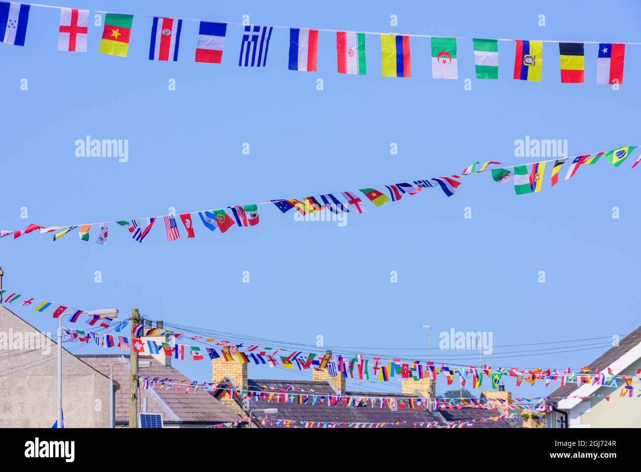 Bunting made from international flags festoon the village of Strangford, County Down, Northern Ireland, United Kingdom, UK. Stock Photo