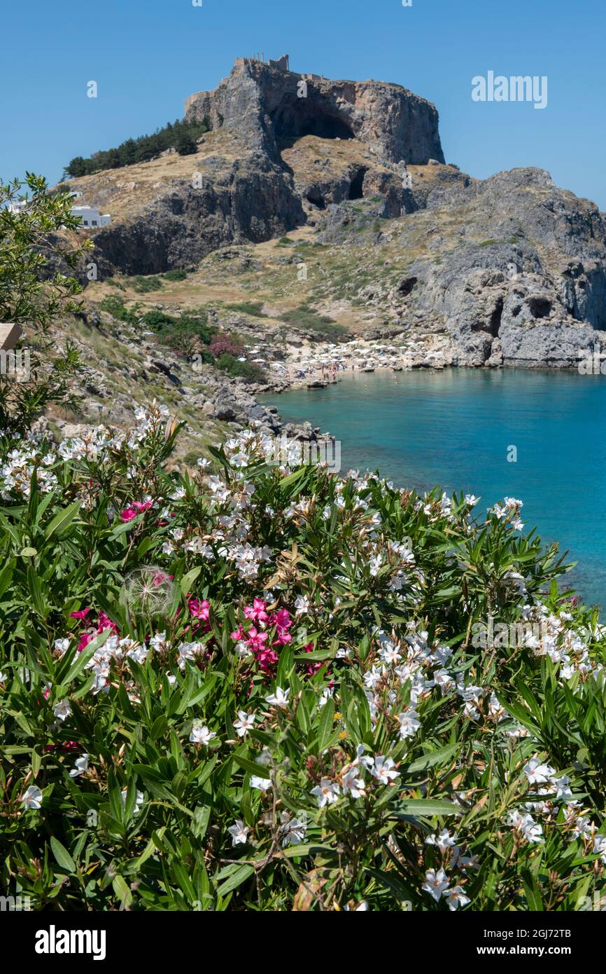 Greece, Rhodes. St. Paul's Bay with the Acropolis of Lindos in the distance with the Temple of Athena Lindia. Stock Photo