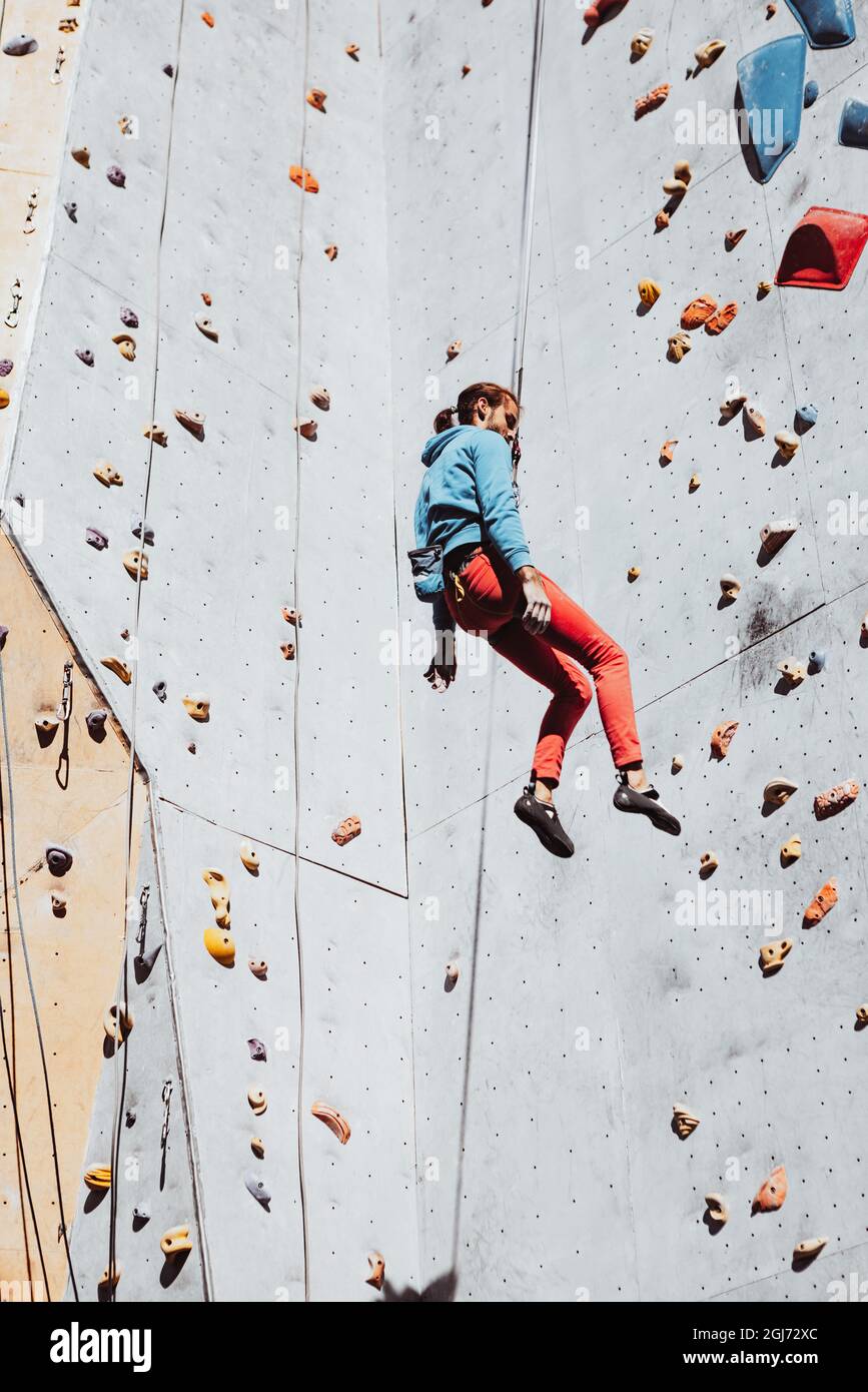 Daily workouts. Young man professional rock climber practicing at ...