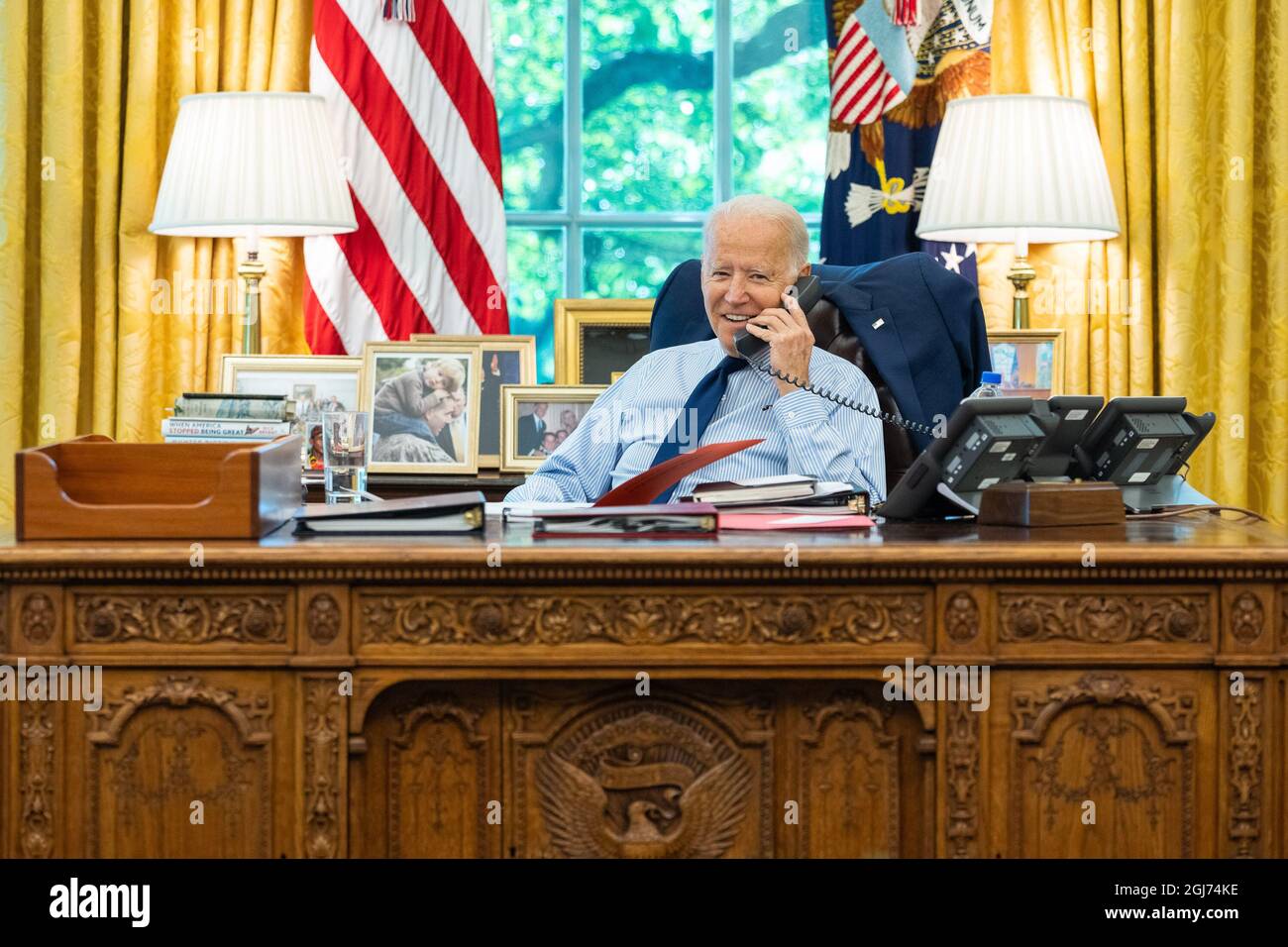 USA. 16th July, 2021. President Joe Biden talks on the phone with U.S. Sen. Angus King, I-Maine, during congressional call time on Friday, July 16, 2021, in the Oval Office of the White House. (Official White House Photo by Adam Schultz via Credit: Sipa USA/Alamy Live News Stock Photo