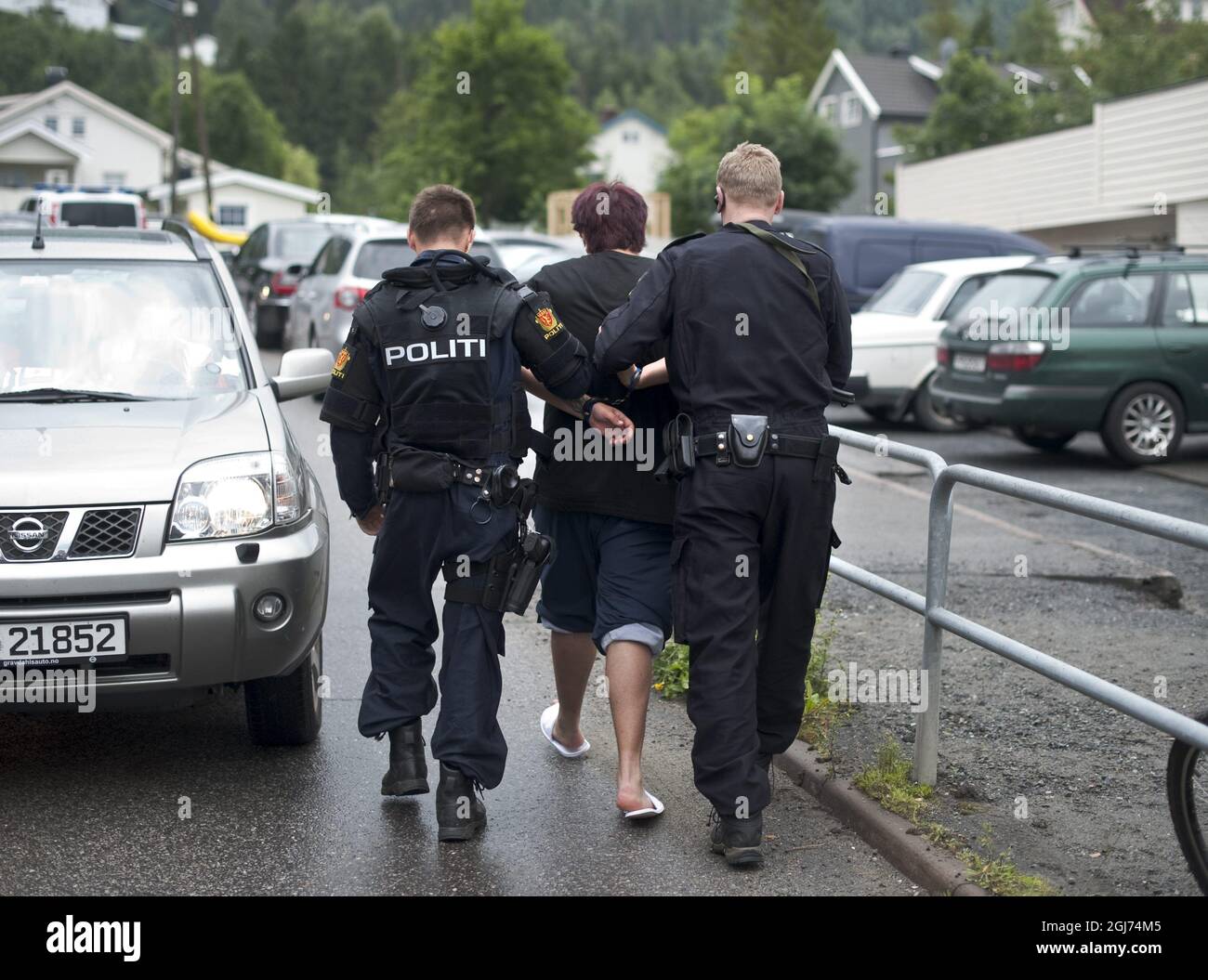 OSLO 20110723 Norwegian police detain a young man, center, accused of carrying a knife outside a hotel where Norway's prime minister was meeting families of shooting victims in Sundvollen, Norway Saturday July 23, 2011. The man told reporters he was a member of the Labor Party's youth wing and was carrying a knife 'because I feel unsafe.' FOTO BjÃ¶rn Larsson Rosvall / SCANPIX / Kod 9200 Stock Photo