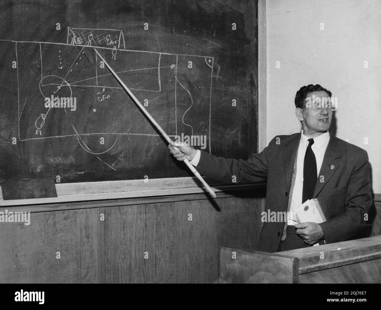 STOCKHOLM 1957-06-06 National team coach George Raynor explains football tactics on the blackboard at Lillsveds education center outside Stockholm. George Raynor (1907-1985), English footballer and manager. He was the coach of Sweden's national football team during the 1940 - and 1950's. He led them to Olympic gold in 1948 and Olympic bronze 1952. In the World Cup, he managed to take Sweden to a bronze in 1950 and silver 1958. Stock Photo