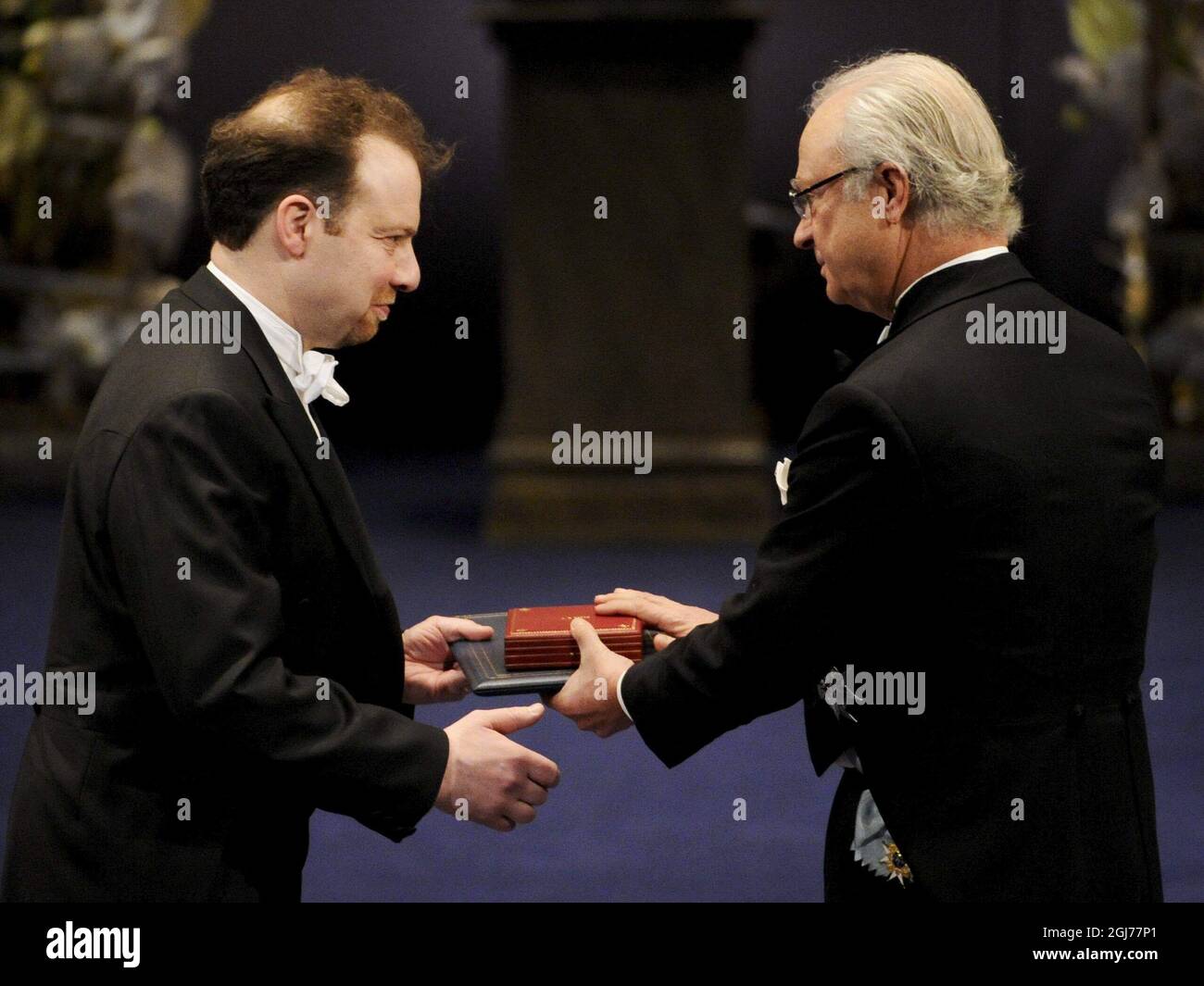 STOCKHOLM 2011-12-10  Professor Adam G. Riess of the Johns Hopkins University, Baltimore, MD, USA, Space Telescope Science Institute, Baltimore, MD, USA is awarded the Nobel Prize in Physics 2011 by King Carl Gustaf of Sweden during the Nobel award ceremony in the Concert Hall of Stockholm Sweden, December 10, 2011.  Professor Riess, received the award for”the discovery of the accelerating expansion of the Universe through observations of distant supernovae'  Foto: Anders Wiklund / SCANPIX  kod 10040 Stock Photo