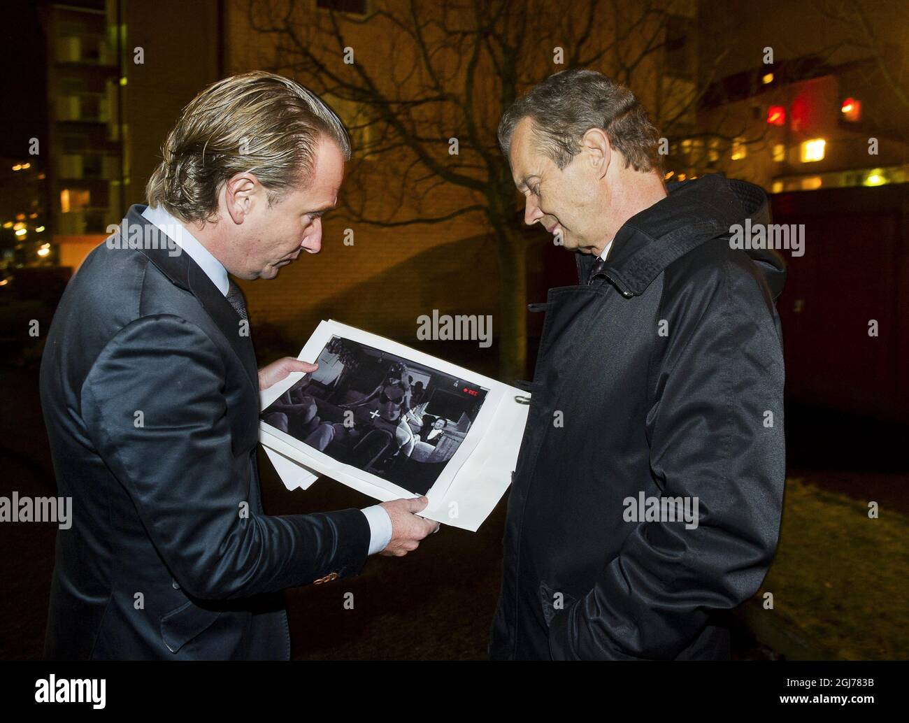 Newspaper Expressen´s reporter Johan T Lindwall (L) shows the picture for Bertil Ternert (R) Information Chief of the Royal Court in Stockholm. Swedish News paper Expressen today published the controversial picture allegedly of King Carl Gustaf and scantily clad women. Foto: Suvad Mrkonjic / XP / SCANPIX SWEDEN / kod 7116 ** OUT SWEDEN OUT ** Stock Photo