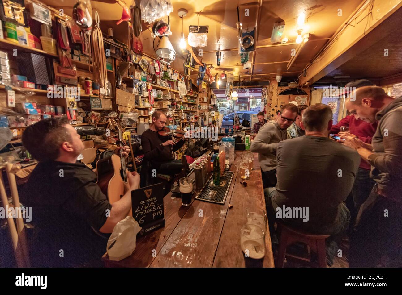 Local musicians play traditional Irish music at Foxy John's pub in Dingle, Ireland Stock Photo