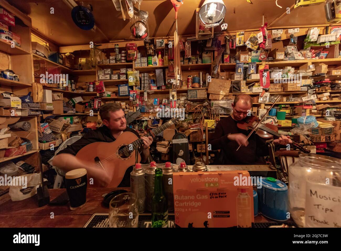Local musicians play traditional Irish music at Foxy John's pub in Dingle, Ireland Stock Photo