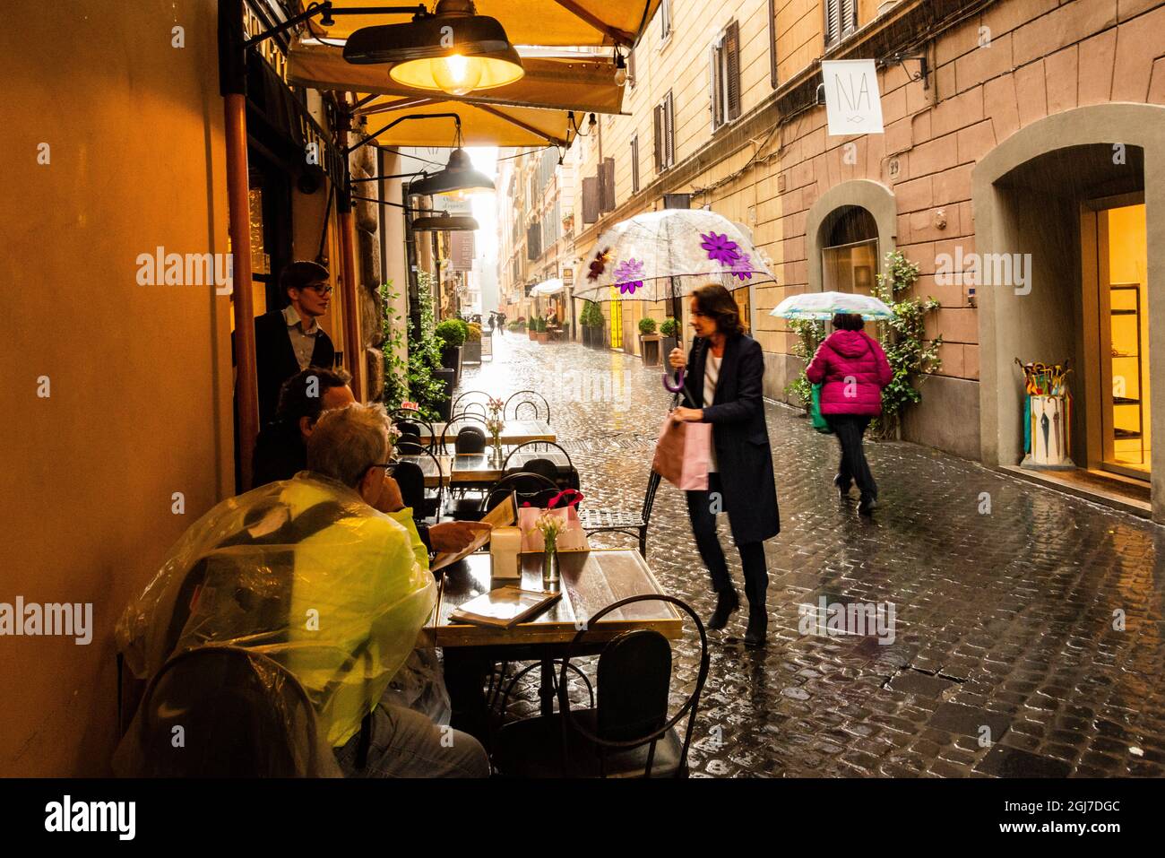 Via Vittora Rome Italy, Rome. Via Vittoria, cafe and wet pavement in the rain ...
