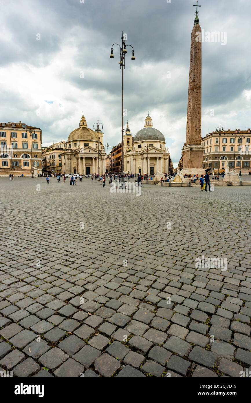 Italy, Rome. Piazza del Popolo, foreground of cobblestones with Flaminio obelisk (3,200 yrs old), built in kingdom of Pharaohs Ramesses II and Mernept Stock Photo