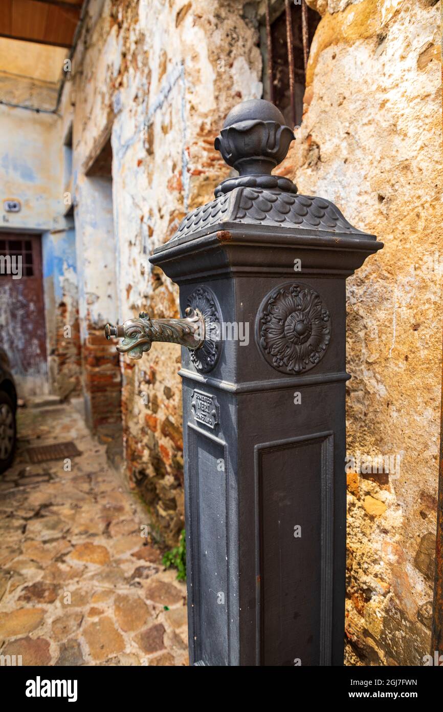 Italy, Sicily, Messina Province, Caronia. A free standing water spigot in a stone alleyway in the hilltop medieval town of Caronia. Stock Photo