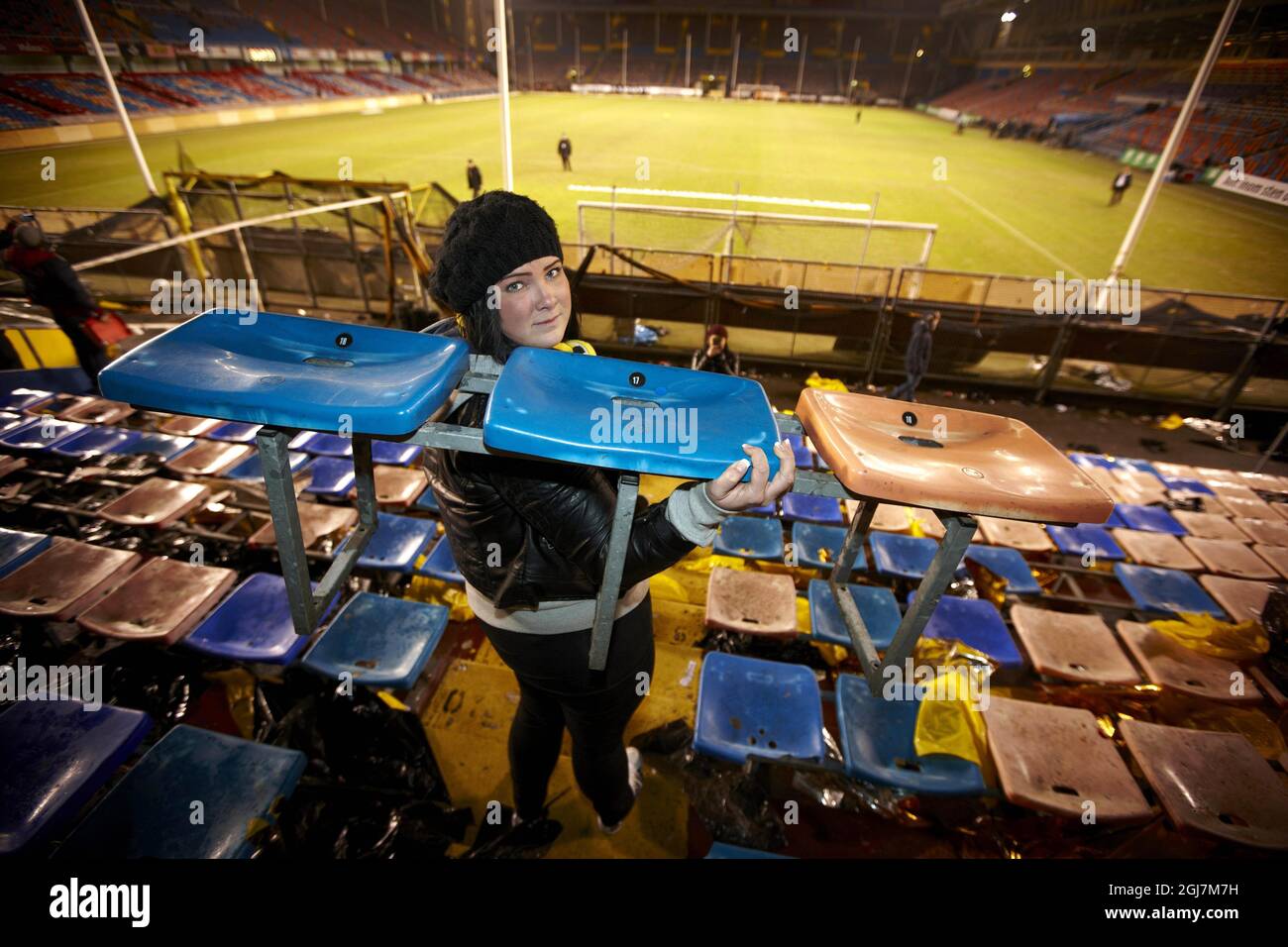 STOCKHOLM 20121122 AIK supporter Josefin carries home the seat she has been sitting on since she was a child after AIK played their last soccer match on RÃ¥sunda stadium on Sunday November 22 2012.. Swedish football fans descended upon the RÃ¥sunda stadium in northern Stockholm to take home souvenirs before the grounds are officially demolished. Foto: Fredrik Persson / SCANPIX / Kod 75906 Stock Photo