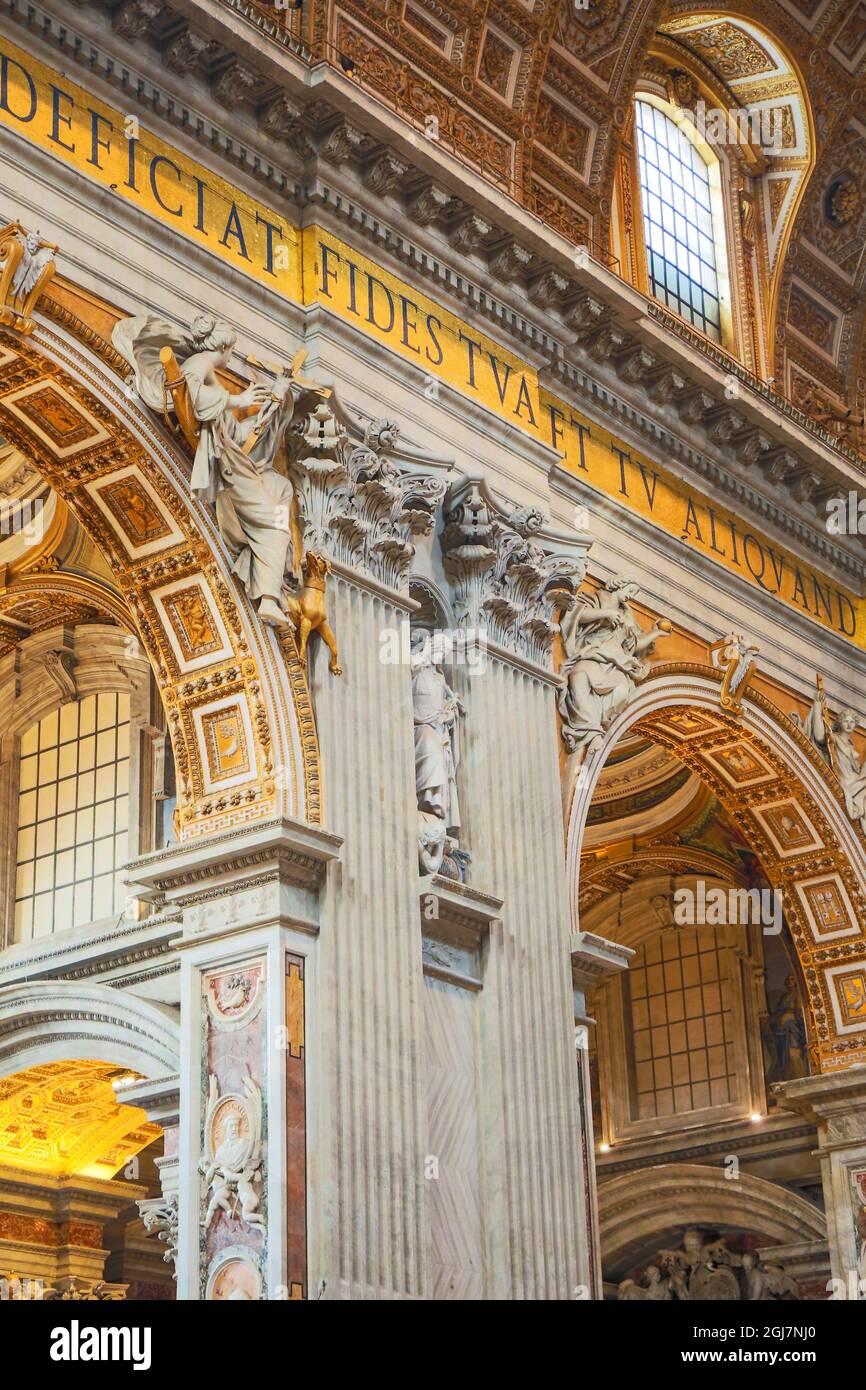 Vatican City State, Europe. Interior view a column and arch in the architecture of St. Peter's Basilica. (For editorial use only) Stock Photo
