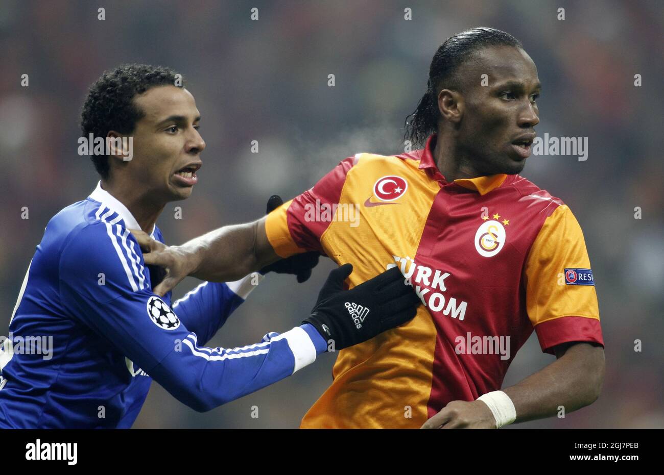 Galatasaray's Didier Drogba (right) and Schalke 04's Joel Matip during their UEFA Champions League Round of 16 First Leg match Galatasaray between Schalke 04 at the TT Arena Ali Sami Yen Spor Kompleksi in Istanbul, Turkey on Wednesday 20 February 2013. Stock Photo