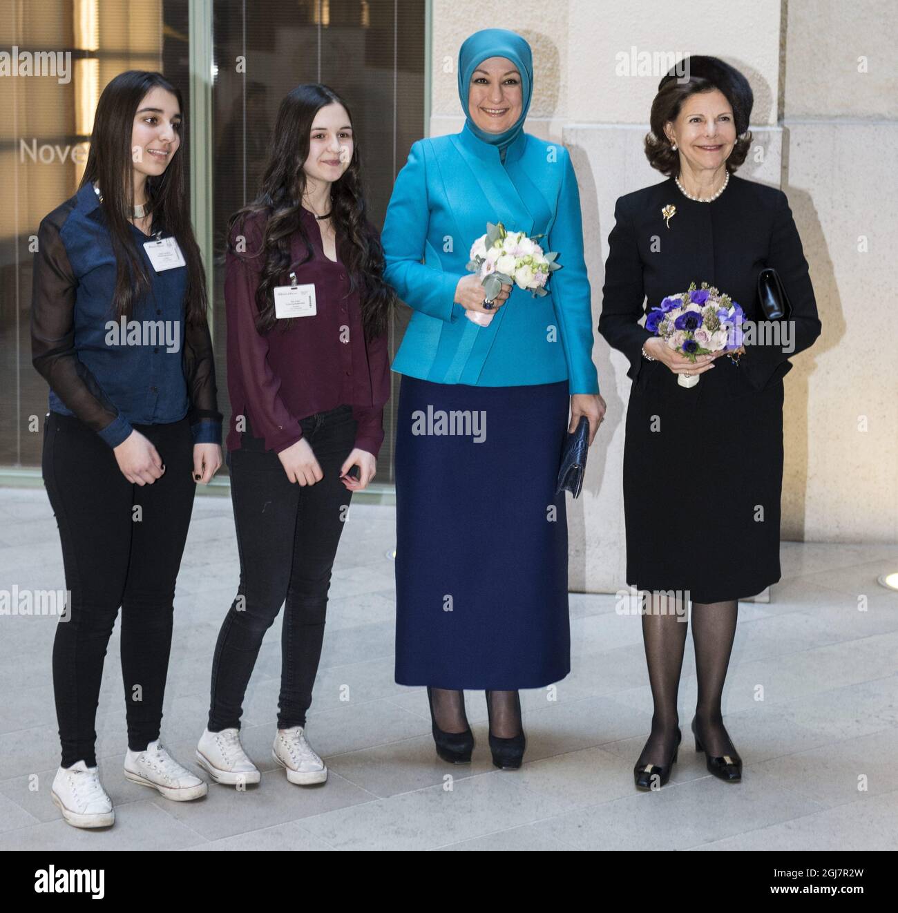 Sweden's Queen Silvia, right, Turkey's First Lady Hayrunnisa Gul, 2nd right, are welcomed with flowres by Dilan Karakus, left, and Nur Eren, 2nd left, from the Rinkeby Acedemy, as they arrive for a lecture at Ernest & Young n Stockholm.The Turkish presidential couple is in Sweden for a trhee-day official state visit.      Stock Photo