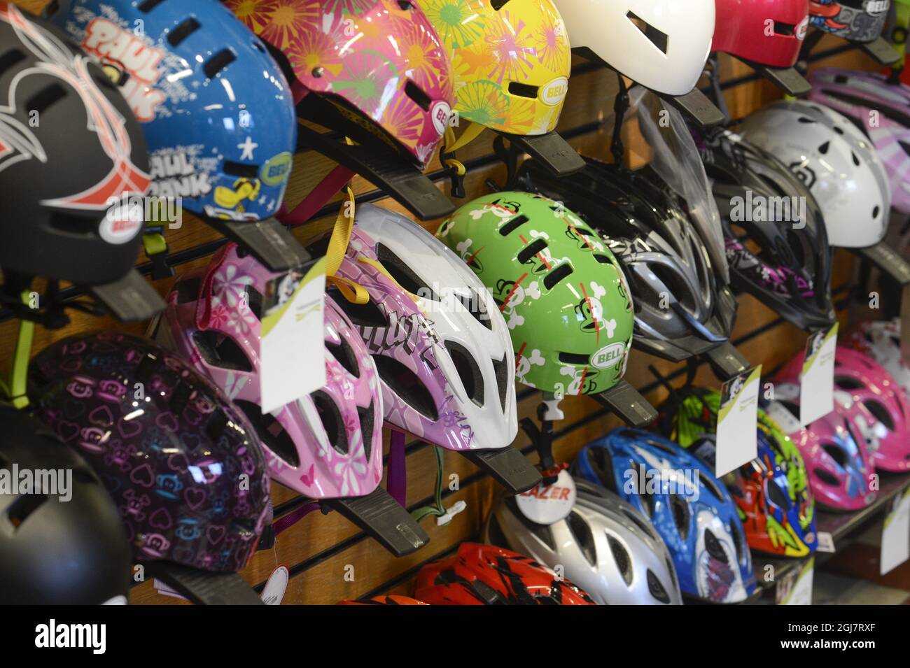 Various bicycle helmets in a bicyle store Stock Photo