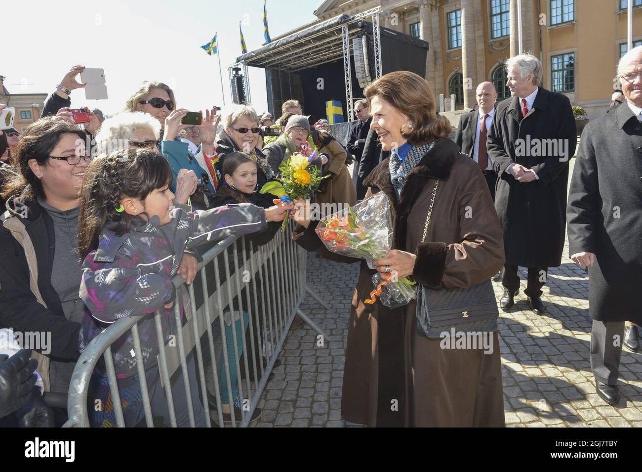 KARLSKRONA 2013-04-06 Queen Silvia receives flower from a small girl at the main square in Karlskrona, Southern Sweden, on April 6, 2013. The King and Queen are touring Sweden to mark the King's 40th anniversay on the throne. Foto: Jonas EkstrÃ¶mer / SCANPIX / Kod 10030 Stock Photo