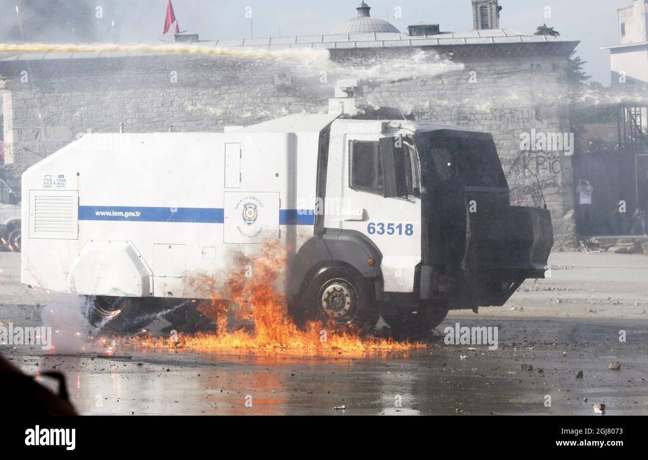 ISTANBUL 2013-06-11 A riot police water cannon burns after a molotov cocktail hit it during clashes at Taksim Square Istanbul, Turkey, 11 June 2013. Turkey's crackdown on opposition protesters that reports said left at least two dead and more than 1,000 injured was 'truly disgraceful,' Amnesty International said 02 June, on a third day of the demonstrations. Demonstrations against the Islamic-conservative government of Prime Minister Recep Tayyip Erdogan began on 31 May when a police crackdown against a peaceful sit-in staged by environmentalists angered over a development project in Istanbul Stock Photo
