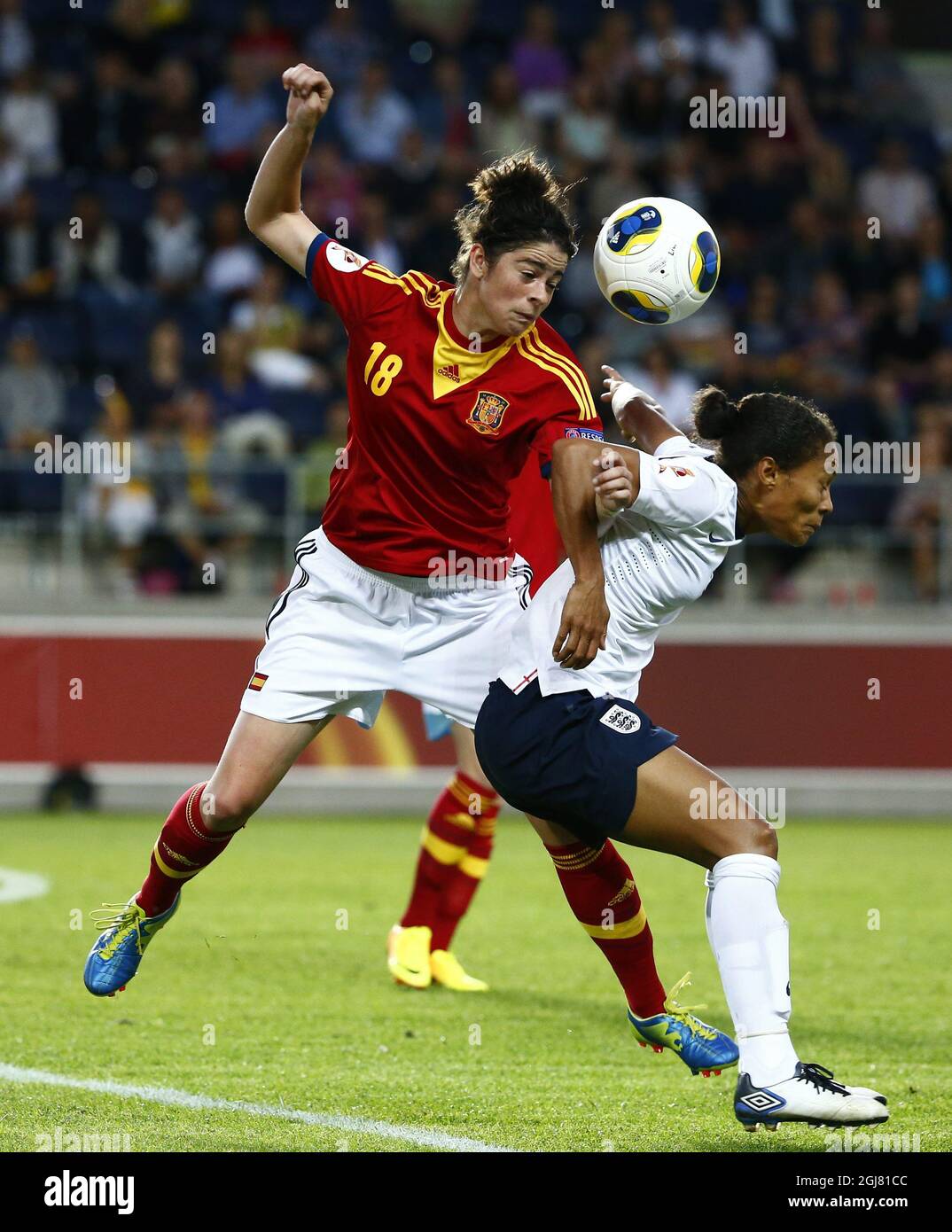 Spain's Marta Torrejon (L) fights for the ball with England's