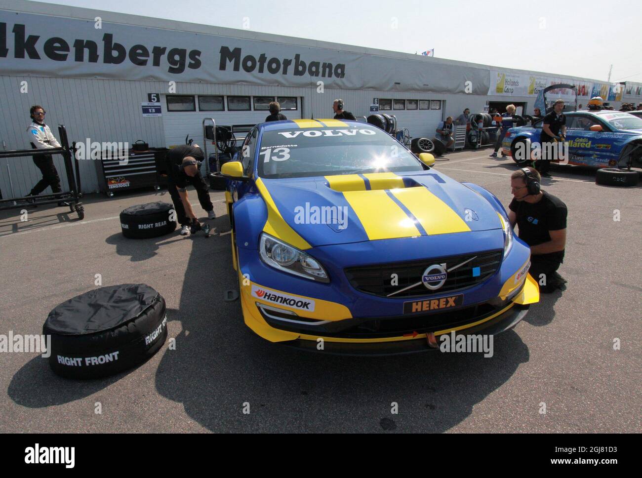 FALKENBERG 2013-07-12 Sweden's Prince Carl Philip, left, on his way to his car before the start of the STCC Test 1 race in Falkenberg, Sweden, on July 12, 2013. Just after he had finished his fourth lap of the race, he got problem with his car. In the first turn, right after the start-line, his car slips sideways, and turns to the wrong side of the driving direction. Carl-Philip had to make a complicated turn to straighten his car up again. Despite the accident, Carl-Philip completes the test. Photo: Niklas Henrikczon / SCANPIX / code 76192 *** SWEDEN OUT ***  Stock Photo