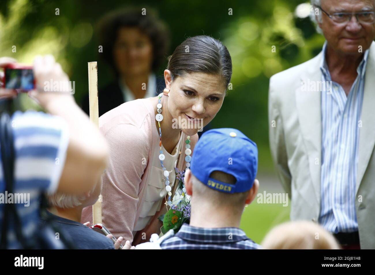 BORGHOLM 20130714 Swedish Crown Princess Victoria and King Carl Gustaf greet the people at the courtyard of the royal family's summer residence Solliden, on the island of Oeland, Sweden, on July 14, 2012, during the celebrations of Crown Princess Victorias 36th birthday. Photo: Jonas Ekstromer / SCANPIX / code 610030  Stock Photo