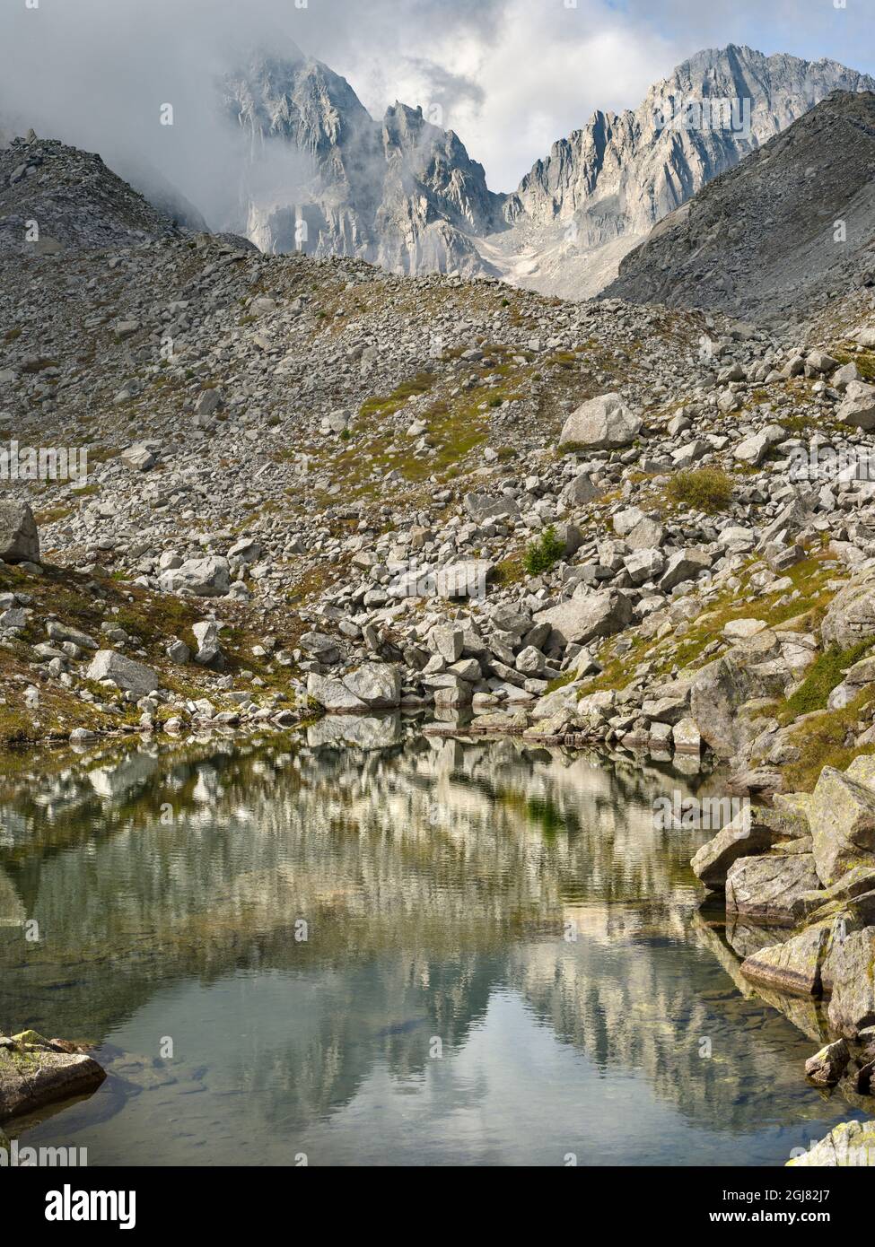 View towards Cima Presanella draped in clouds near Rifugio Segantini. Presanella mountain range, Parco Naturale Adamello, Brenta, Trentino, Italy, Val Stock Photo