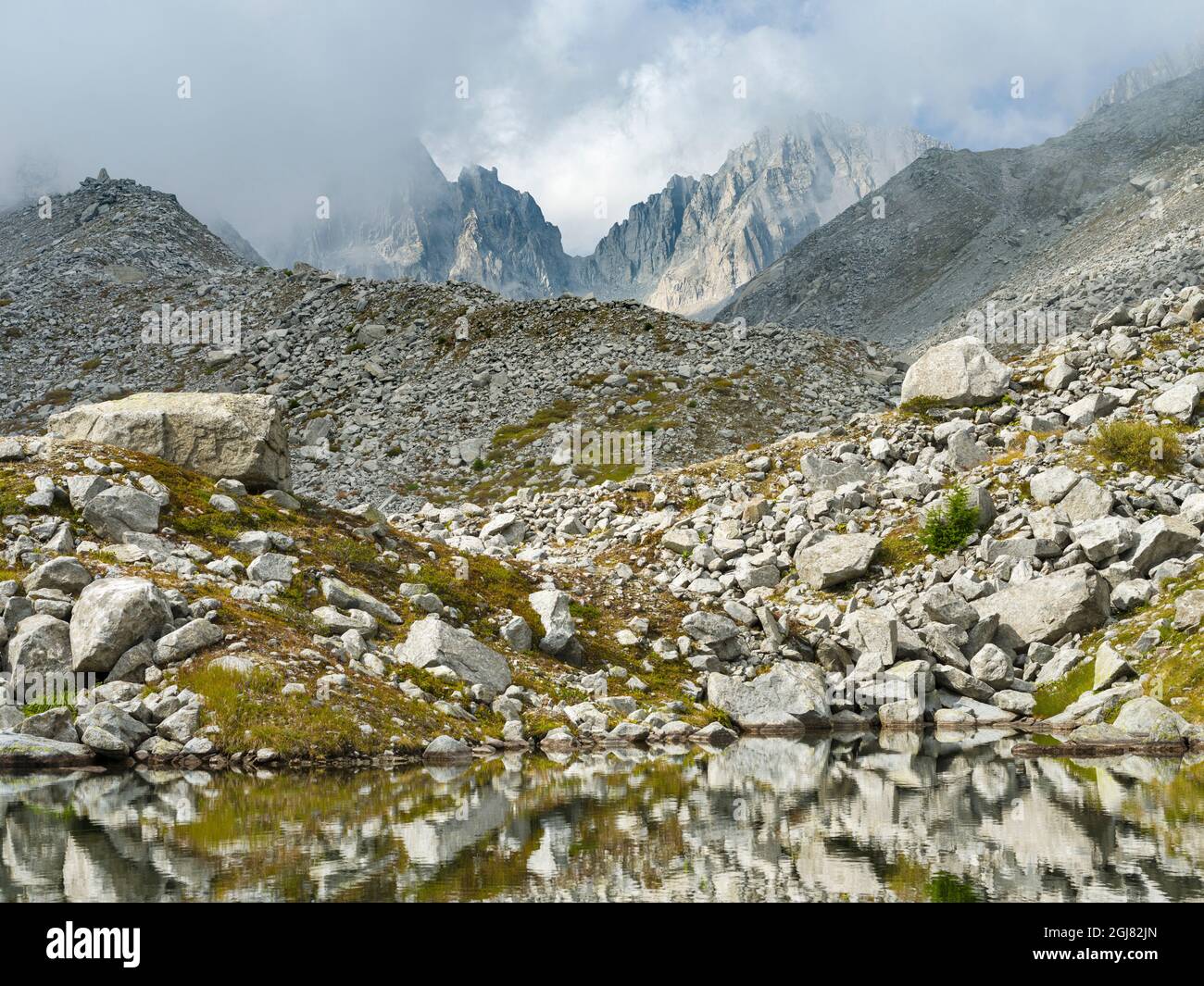 View towards Cima Presanella draped in clouds near Rifugio Segantini. Presanella mountain range, Parco Naturale Adamello, Brenta, Trentino, Italy, Val Stock Photo