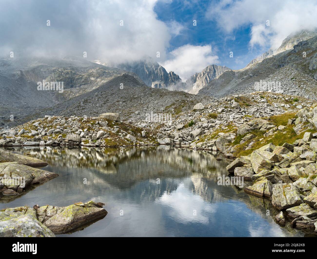 View towards Cima Presanella draped in clouds near Rifugio Segantini. Presanella mountain range, Parco Naturale Adamello, Brenta, Trentino, Italy, Val Stock Photo