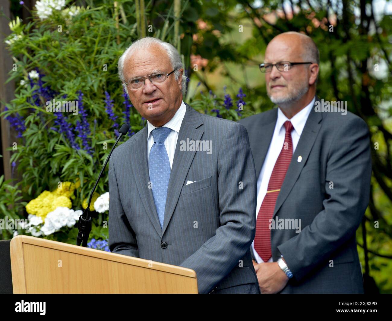 LULEA 20130816 King Carl Gustaf gives a speach at the city park of Lulea, Sweden, August 16, 2013. Behind him county governor Sven-Erik Ostberg. The visit is a part of the KingÂ’s 40 year anniversary on the throne. Foto Jonas Ekstromer / SCANPIX kod 10030  Stock Photo