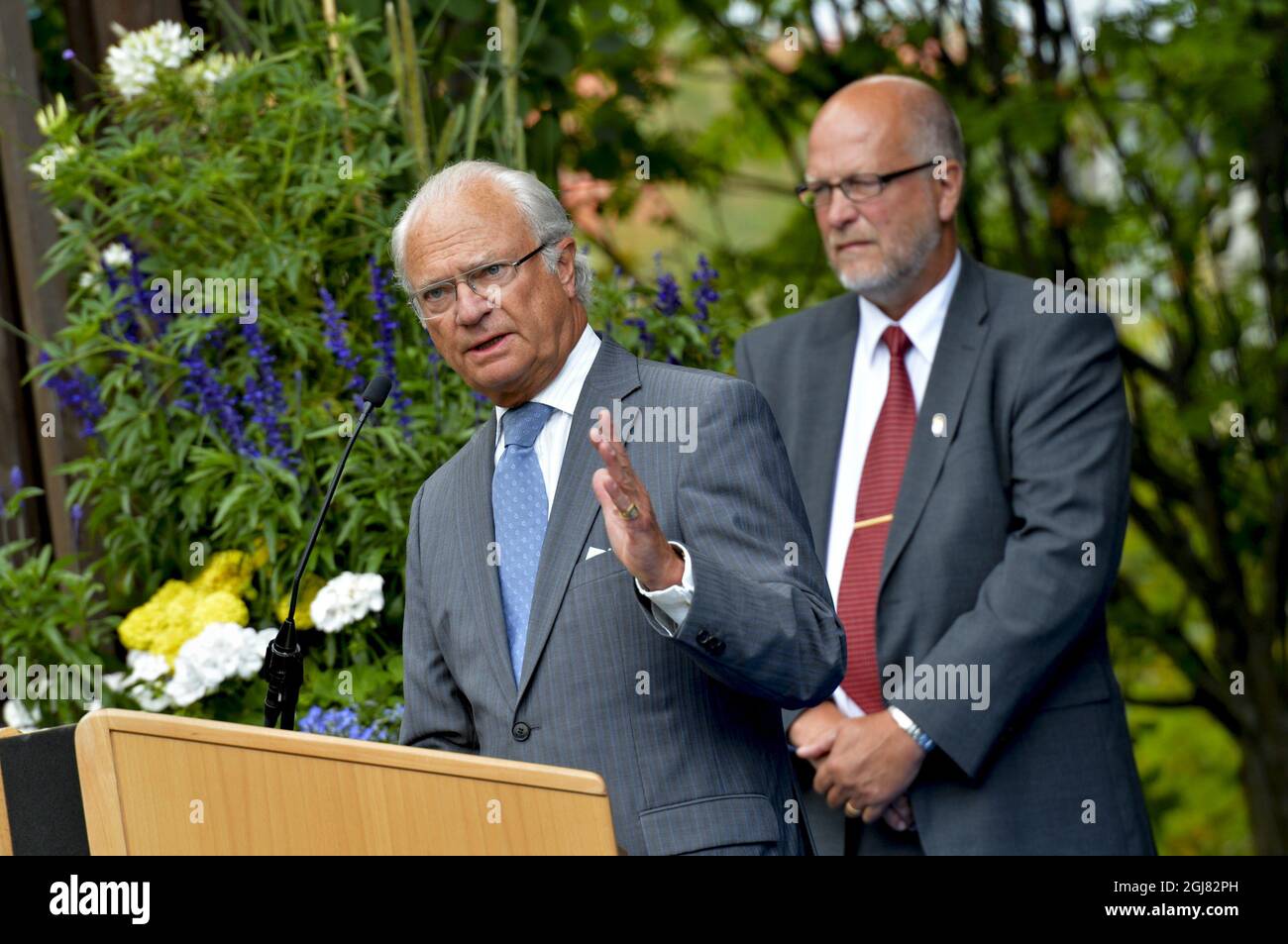LULEA 20130816 King Carl Gustaf gives a speach at the city park of Lulea, Sweden, August 16, 2013. Behind him county governor Sven-Erik Ostberg. The visit is a part of the KingÂ’s 40 year anniversary on the throne. Foto Jonas Ekstromer / SCANPIX kod 10030  Stock Photo