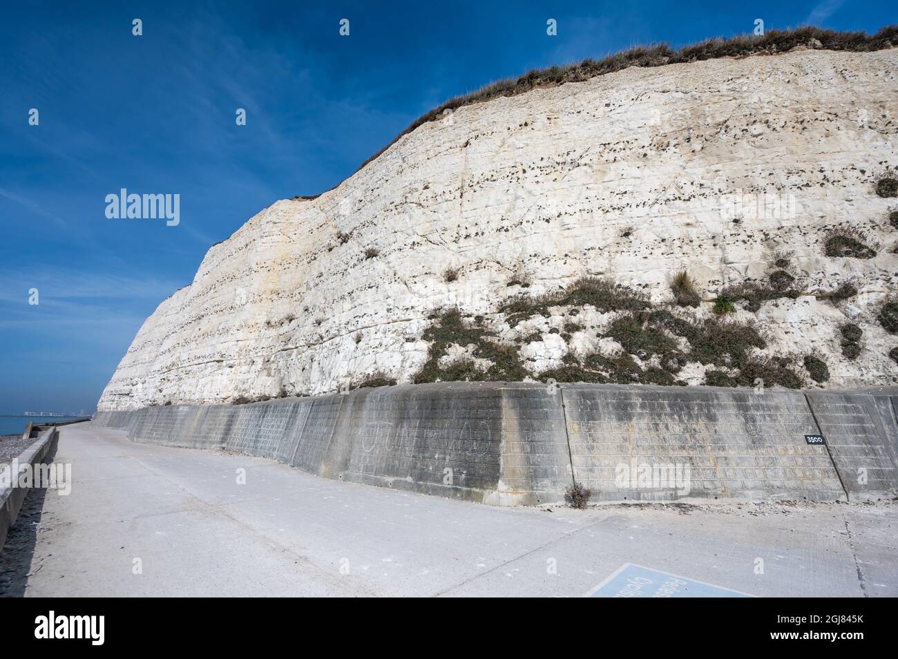 Rottingdean cliff path (cliff walk) and white chalk cliffs in Summer with blue sky in Rottingdean, on the South Coast of East Sussex, England, UK. Stock Photo