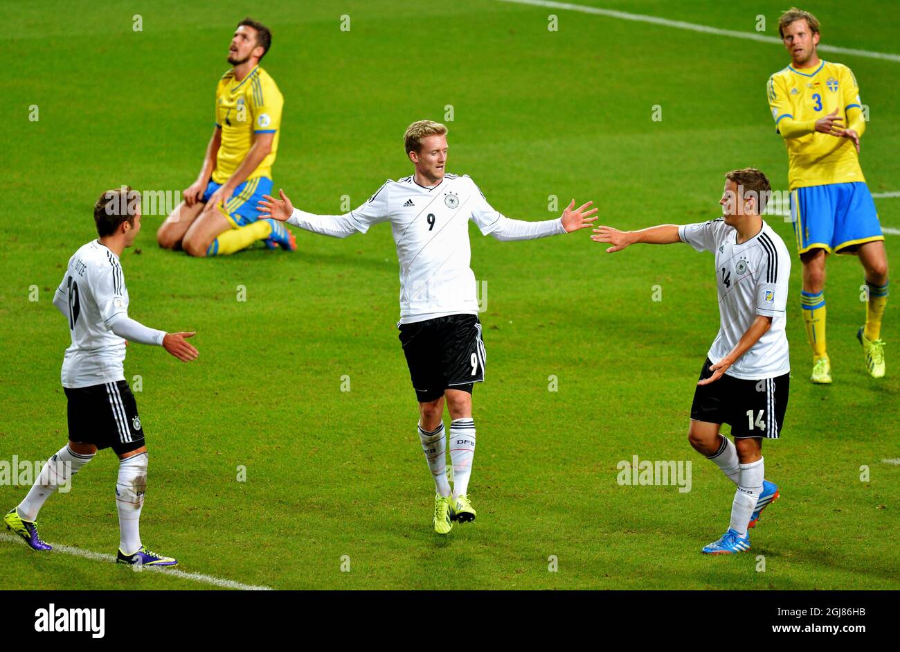 Germany's Andre Schuerrle (C) celebrates scoring with teammates Mario Goetze (L) and Max Kruse while Sweden's Per Nilsson (far L) and Mikael Antonsson look dejected during the 2014 World Cup group C qualifying soccer match between Sweden and Germany at Friends Arena in Stockholm, Sweden, on Oct. 15, 2013. Poto: Jonas Ekstromer / TT / code 10030  Stock Photo