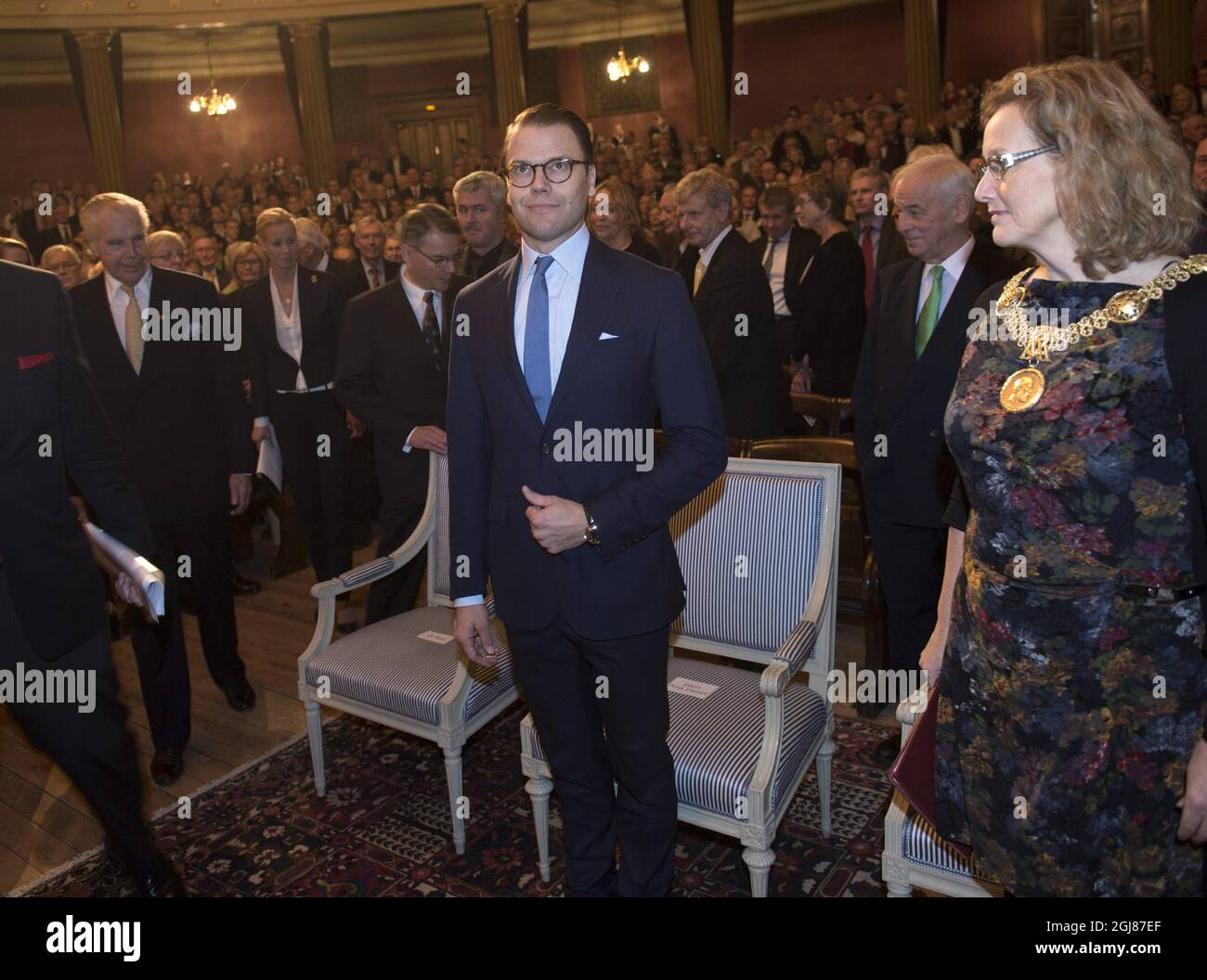 UPPSALA 2013-11-06 Prince Daniel is seen attending the Anders Wall entrepreneurship lecture in the Uppsala University in Uppsala, Sweden. November 6, 2012. At left industrialist Anders Wall and at right University Vice-chancellor Eva Akesson. Foto: Fredrik Sandberg / TT / Kod 10080  Stock Photo
