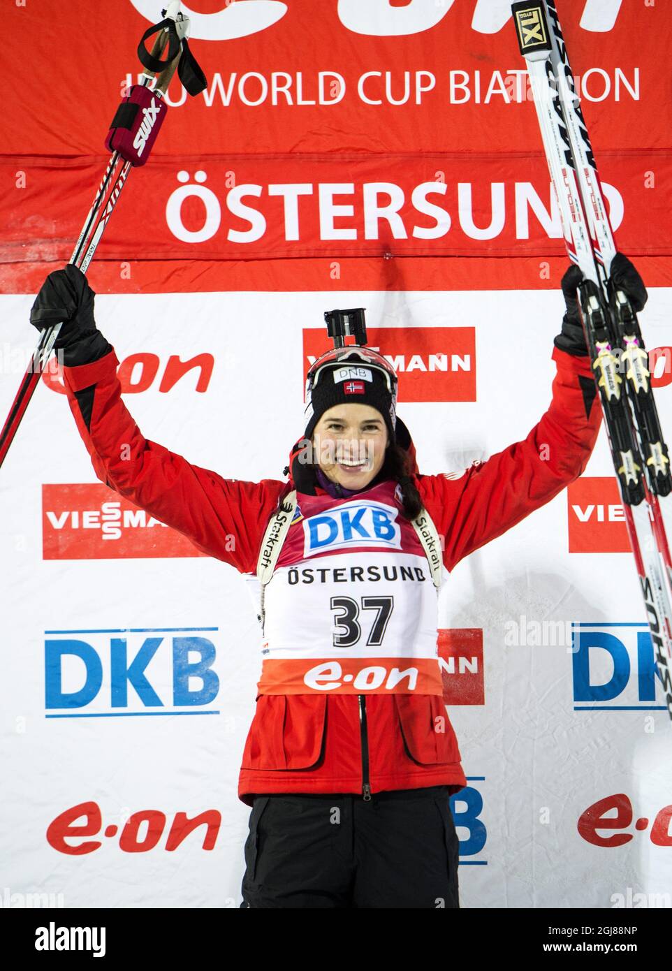 Ann Kristin Flatland of Norway celebrates on the podium after winning the Women's 7,5 km sprint race of the Biathlon World Cup in Ostersund, Sweden, on Nov. 29, 2013. Photo: Pontus Lundahl / TT / code 10050  Stock Photo