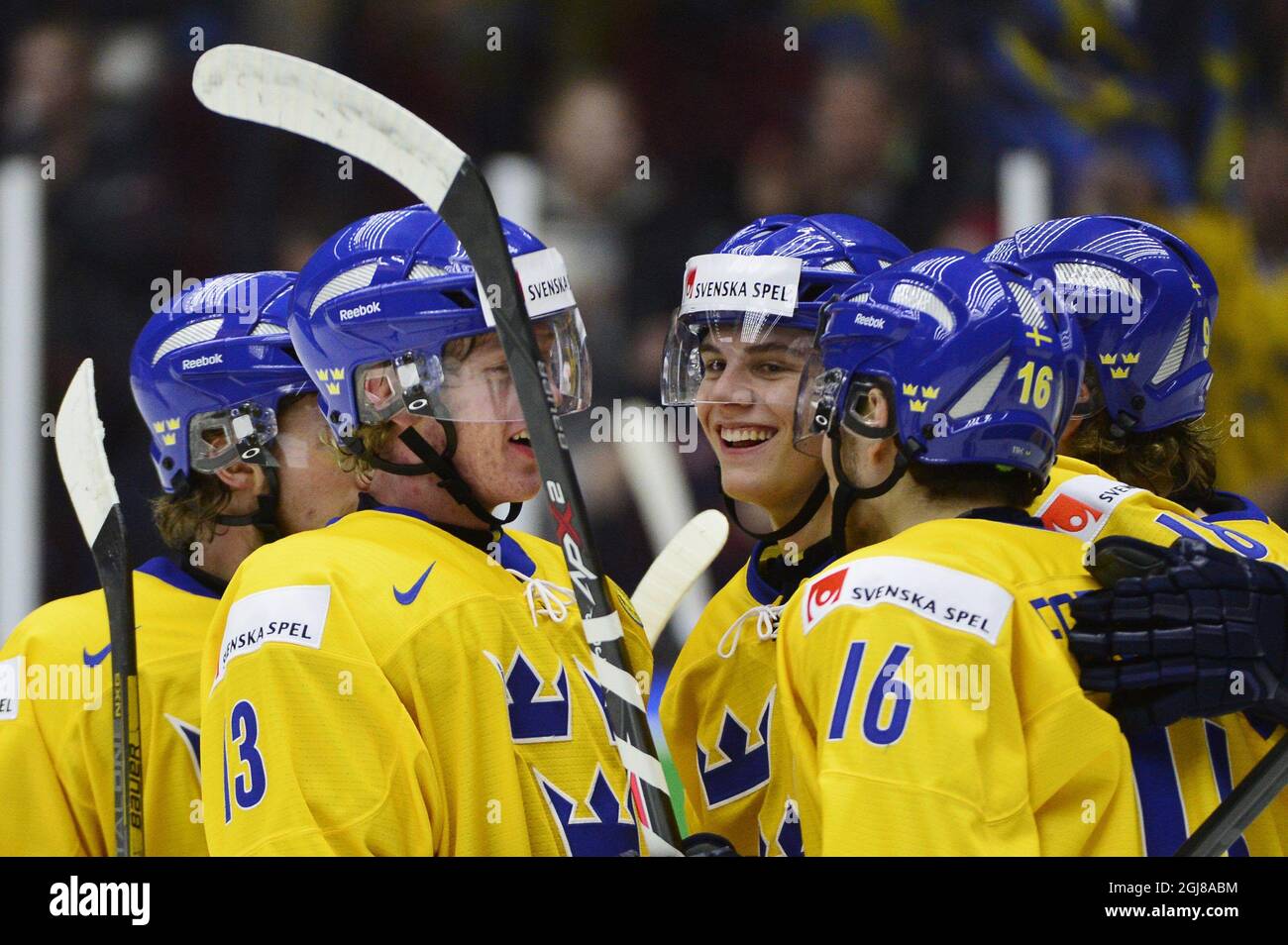 MALMO 2013-12-29 Sweden's Andre Burakowsky (C) celebrates with teammates Gustav Olofsson (nr 13, L) and Filip Forsberg (nr 16, R) after scoring the 0-3 goal during the IIHF World Junior Championship preliminary round group B icehockey match between Norway and Sweden at Malmo Arena in Malmo, Sweden, on Dec. 29, 2013. Photo: Ludvig Thunman / TT / code 10600  Stock Photo