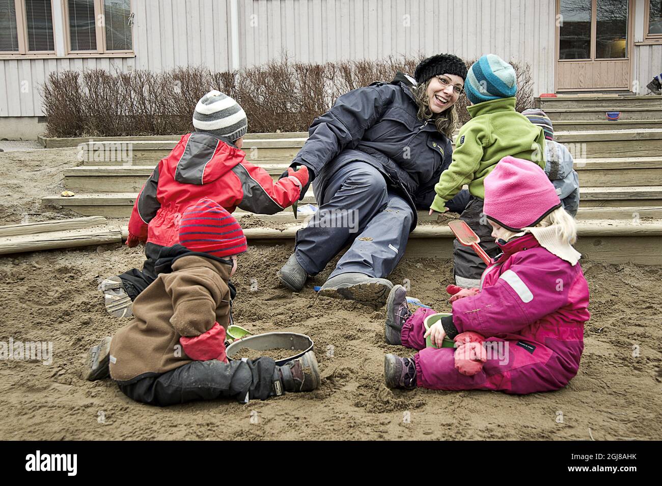 STOCKHOLM 2012-03-16 Children play in the sandbox at preschool Molntappen in Skarpnack, Stockholm, Sweden. Stock Photo