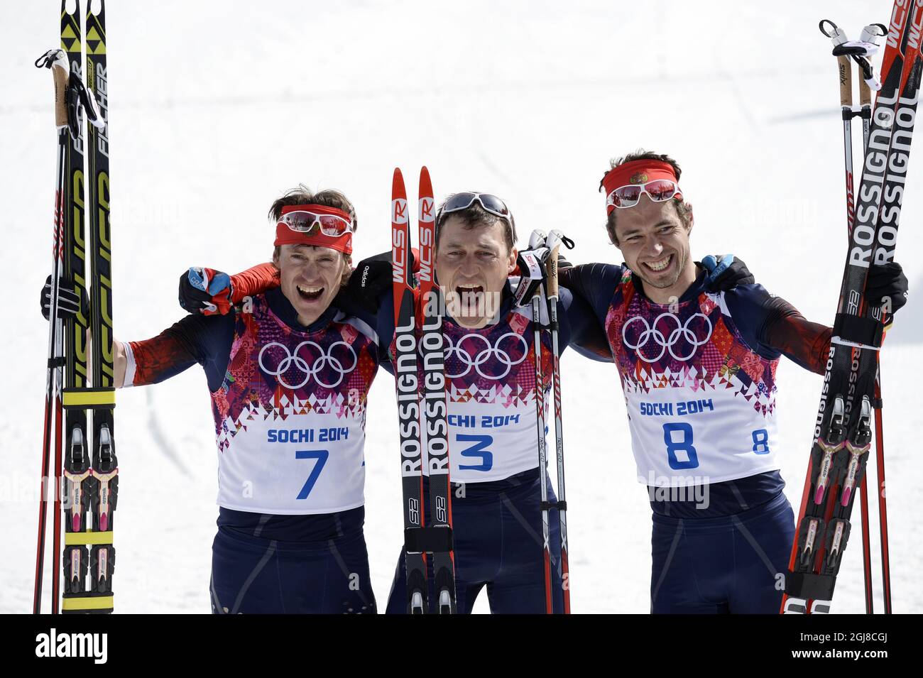SOCHI 2014-02-23 Russia's Alexander LEGKOV celebrates his gold (C) with  compatriots Maxim VYLEGZHANIN (silver) and Ilia CHERNOUSOV (bronze) in the  men's 50 km cross country at the Laura Cross-country Ski & Biathlon