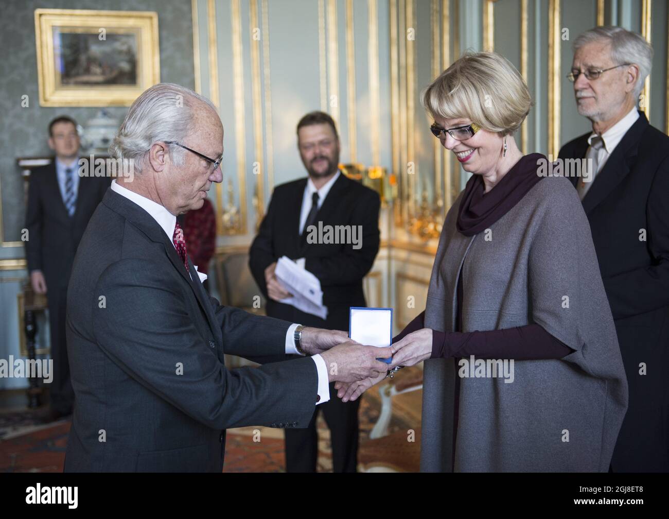 STOCKHOLM 20140414 King Carl XVI Gustaf is seen together with Professor Compton James Tucker of NASA and Professor Gudrun Gisladotti of the University of Iceland during a medal ceremony at the Royal Palace of Sweden, April 14, 2014. Professor Tucker received the Vega medal, a Swedish award to individuals who 'excellently promoted the geographical research'. Professor Gisladottir received the Wahlberg's gold medal for her broad and deep knowledge in the 'land degradation and desertification,Â” The medals are awarded by the Swedish Society for Anthropology and Geography. Foto: Pontus Lundahl /  Stock Photo