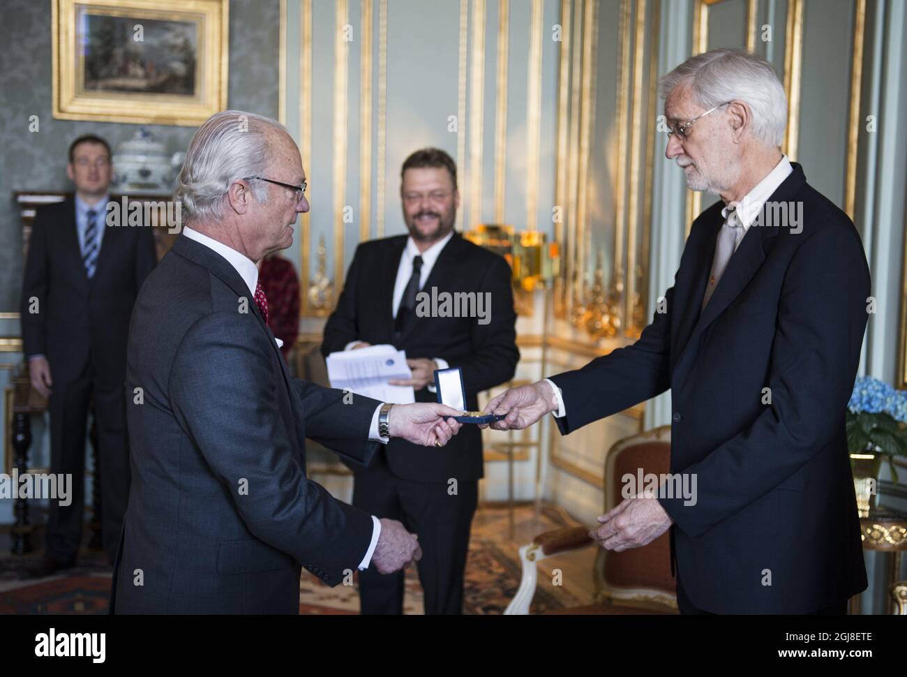 STOCKHOLM 20140414 King Carl XVI Gustaf is seen together with Professor Compton James Tucker of NASA and Professor Gudrun Gisladotti of the University of Iceland during a medal ceremony at the Royal Palace of Sweden, April 14, 2014. Professor Tucker received the Vega medal, a Swedish award to individuals who 'excellently promoted the geographical research'. Professor Gisladottir received the Wahlberg's gold medal for her broad and deep knowledge in the 'land degradation and desertification,Â” The medals are awarded by the Swedish Society for Anthropology and Geography. Foto: Pontus Lundahl /  Stock Photo
