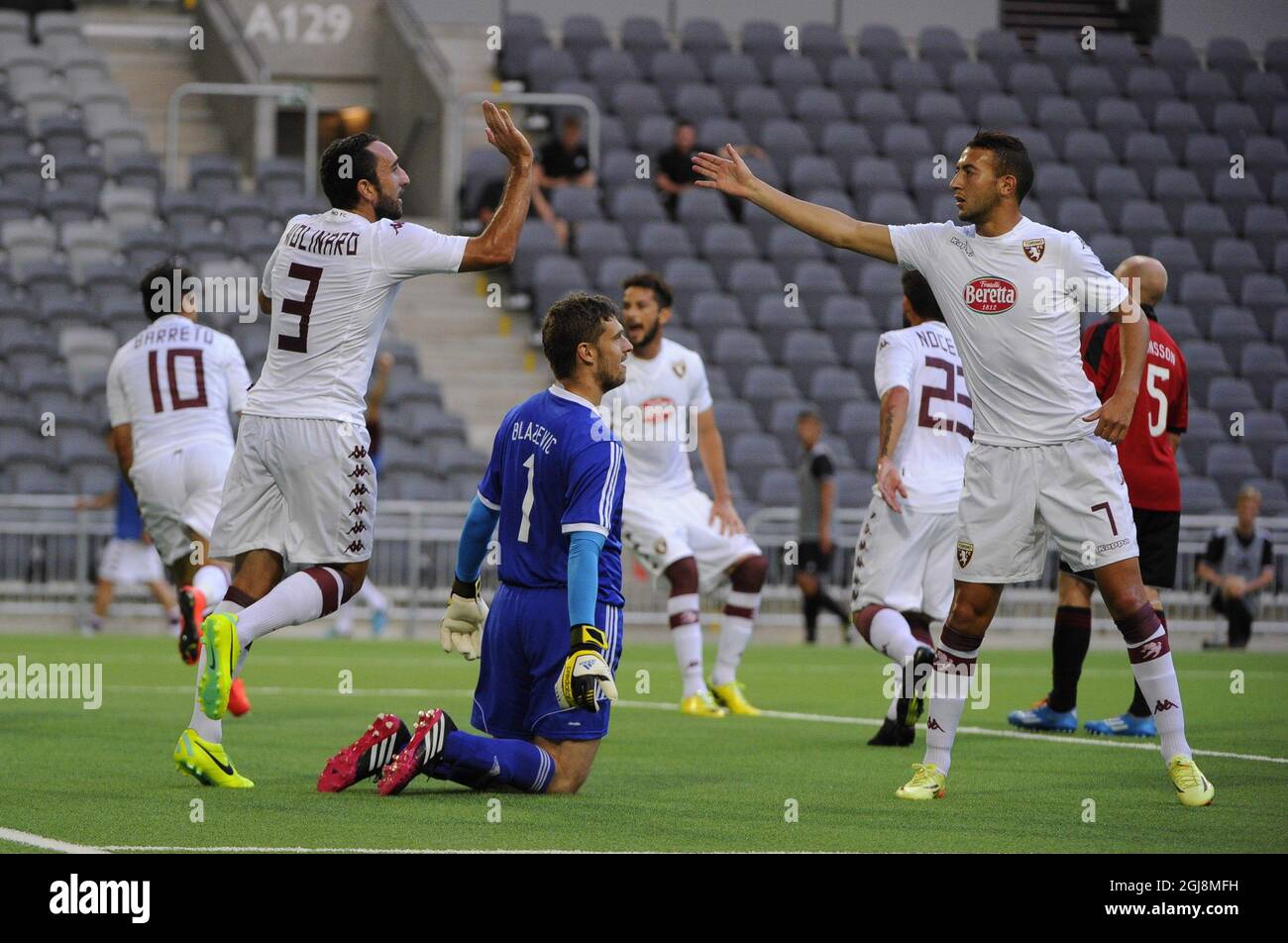 Torino's Paulo Barreto, nr 10 left, Cristian Molinaro, nr 3, and Omar El Kaddouri, right nr 7, celebrate Barreto's 0-3 goal as Brommapojkarna's goalkeeper Davor BlaAÂ¾eviAÂ‡ reacts during the IF Brommapojkarna v. Torino FC UEFA Europa League third qualifying round, first leg soccer match at Friends Arena in Stockholm, Sweden on 31 July 2014. Photo: Annika af Klercker / TT / code 10840  Stock Photo