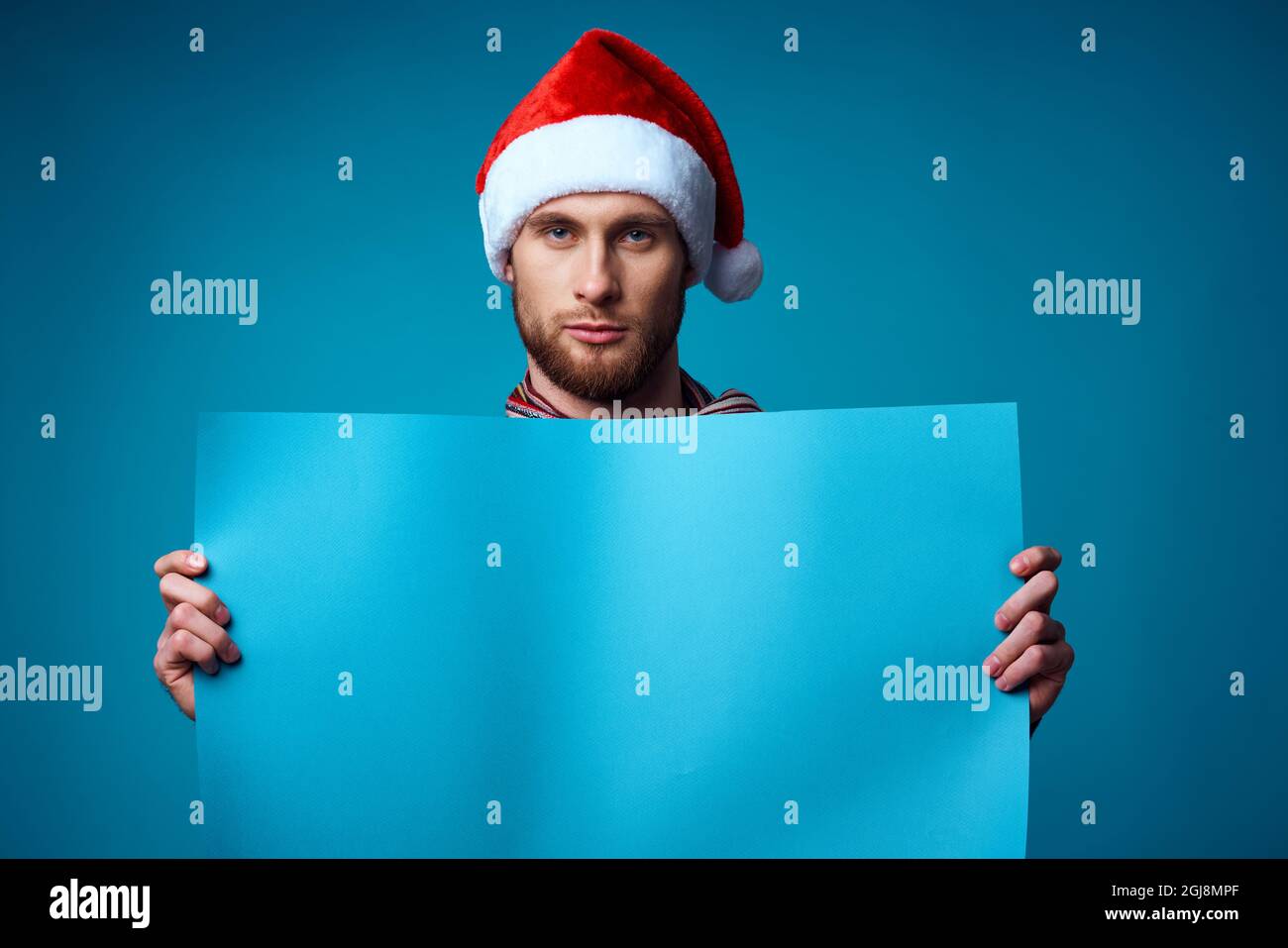 Cheerful man in a santa hat holding a banner holiday isolated ...