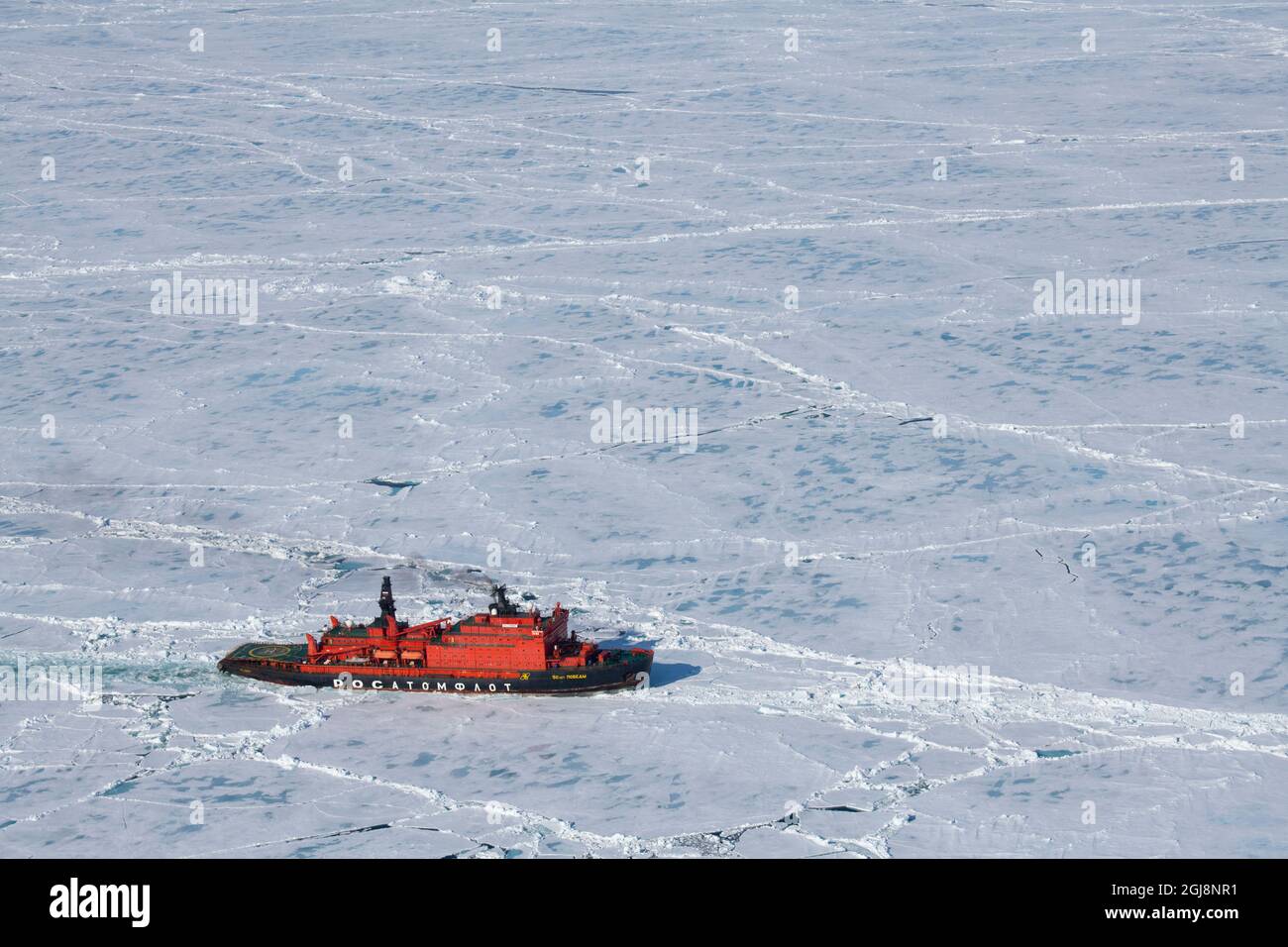 Russia. Aerial view of Russian nuclear icebreaker, 50 Years of Victory. Breaking through pack ice in High Arctic at 85.6 degrees north on the way to t Stock Photo