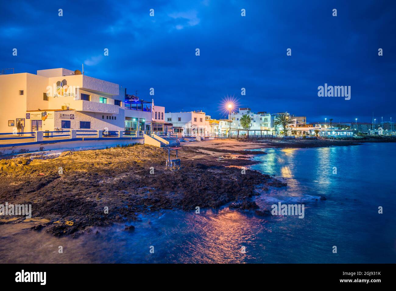 Spain, Canary Islands, Fuerteventura Island, Corralejo, Fisherman's Quarter by Playa Muelle Chico, dusk Stock Photo