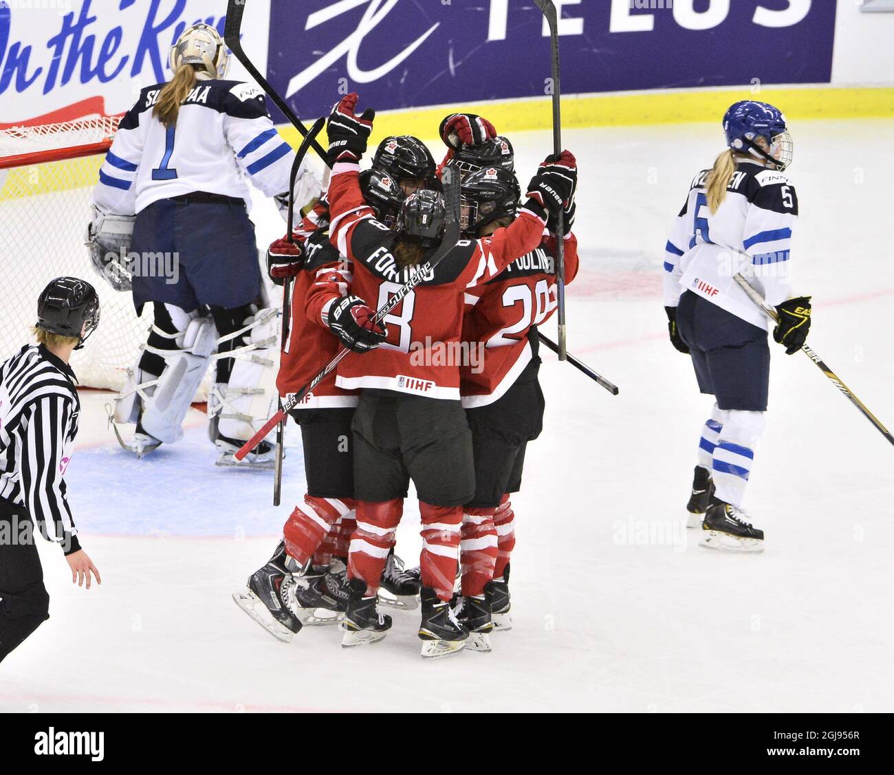 CORRECTION SPELLING AV SCORERS NAME Canadian players celebrate after Brigette Lacquette (4, hidden) scored the opening goal, as Finlands goalkeeper Eveliina Suonpaa (1) and Anna Kilponen (5) looks away during the 2015 IIHF Ice Hockey Women's World Championship group A match between Canada and Finland at Malmo Isstadion in Malmo, southern Sweden, on March 31, 2015. Photo: Claudio Bresciani / TT / code 10090 Stock Photo