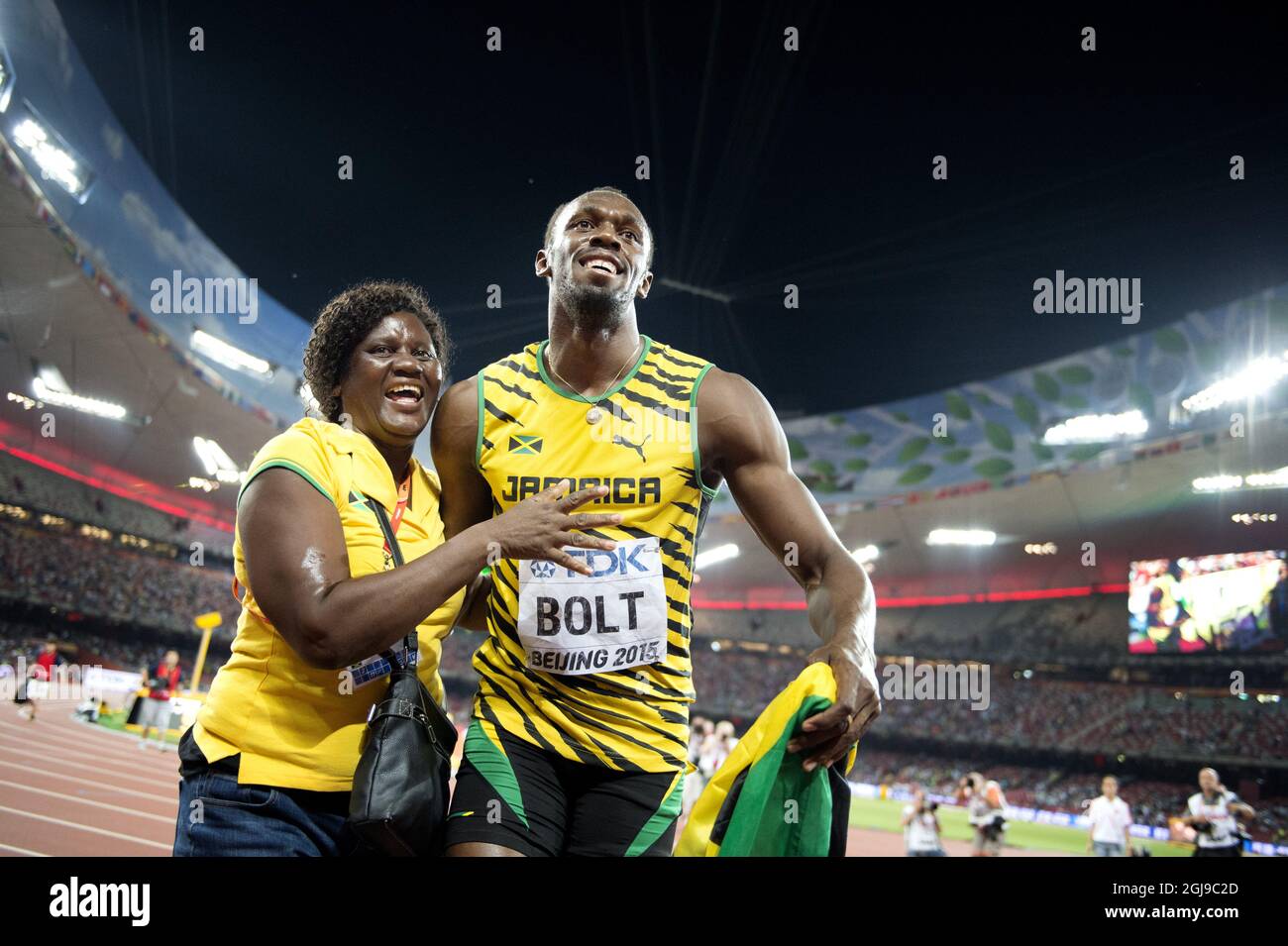 BEIJING 20150823 Usain Bolt of Jamaica gets a hug from his mother Jennifer Bolt after winning the men's 100m final during the Beijing 2015 IAAF World Championships at the National Stadium in Beijing, China, August 23, 2015. Photo: Jessica Gow / TT / Kod 10070  Stock Photo