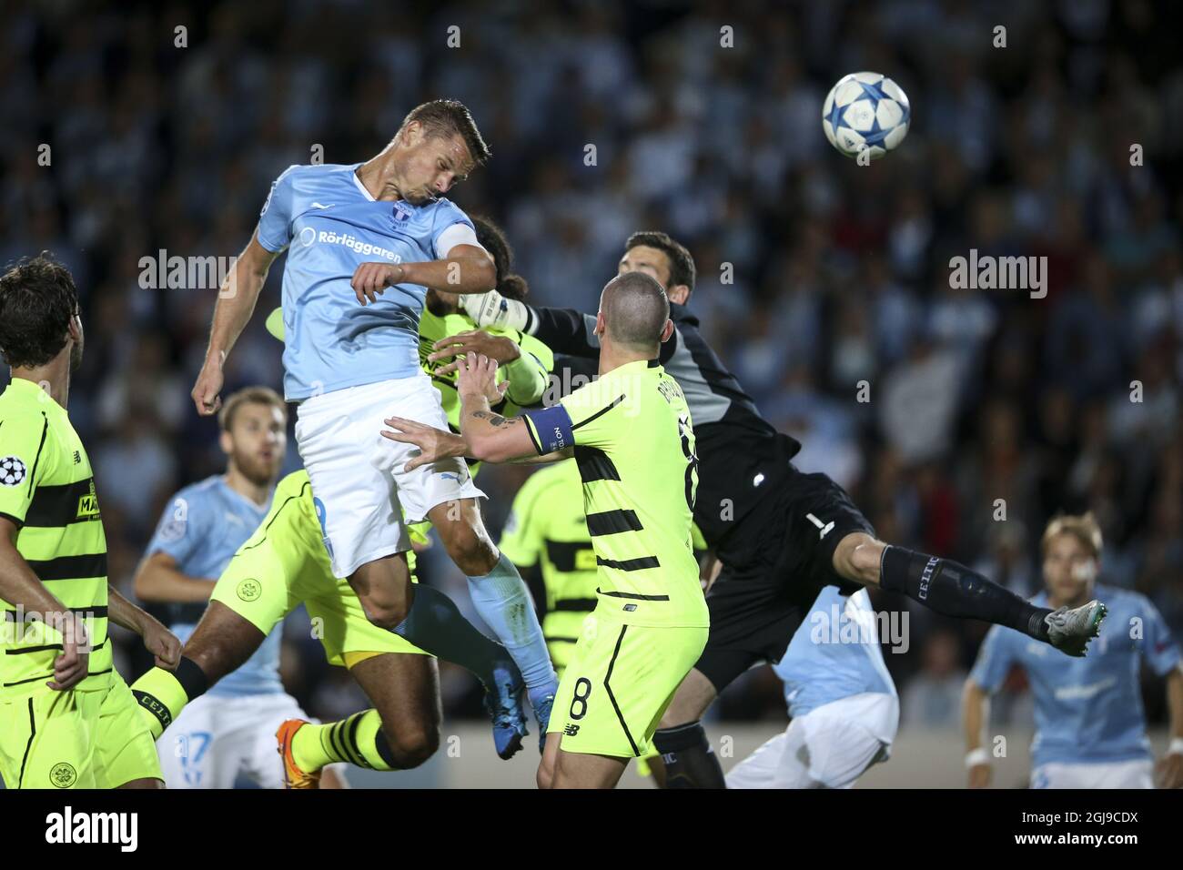 Malmo's Markus Rosenberg (top, center) heads the ball to score the opening goal past Celtics goal keeper Craig Gordon (right) and Celtics Scott Brown (8) during the UEFA Champions League play-off second leg soccer match between Malmo FF and Celtic FC at Malmo New Stadium, in Malmo, Sweden, on Aug. 25, 2015. Photo: Andreas Hillergren / TT / code 10600 Stock Photo