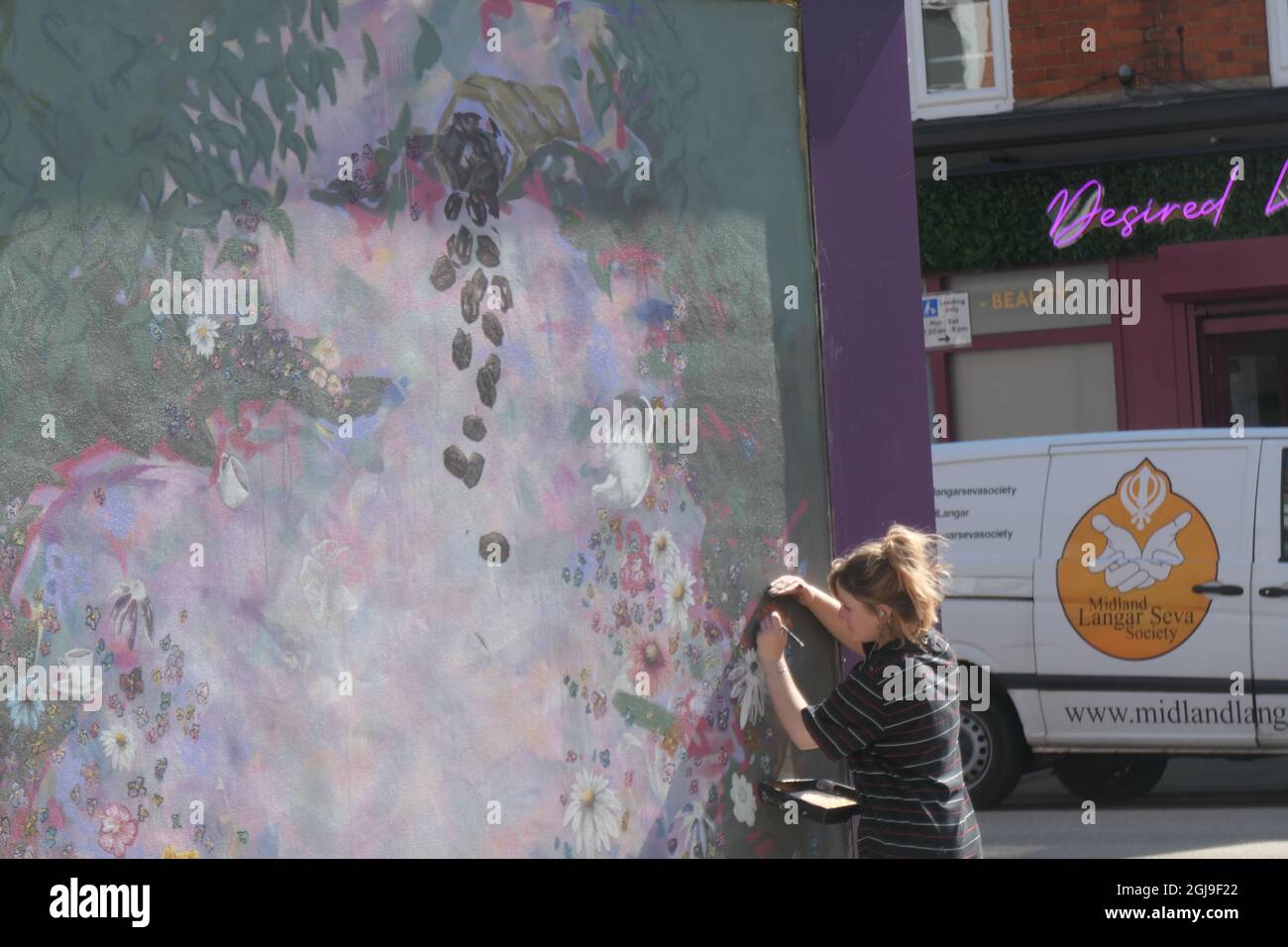 Wall painter artist at Coffee shop Northampton UK Stock Photo Alamy