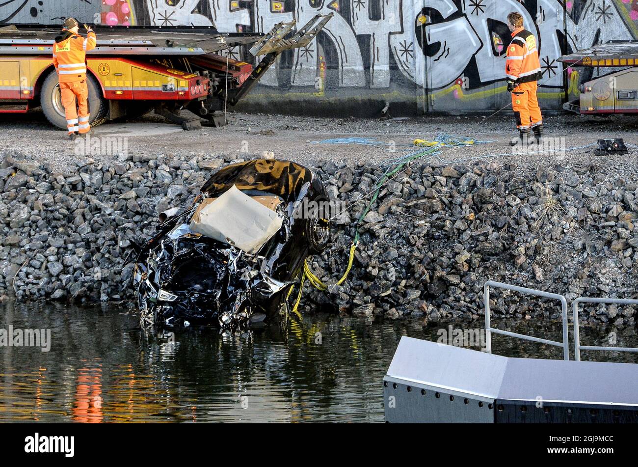 SODERTALJE 2016-02-13 A badly damaged car is towed up from the canal under the E4 highway bridge in Sodertalje, Sweden, February 13, 2016. Three people were killed when their car ran through the gate and flew off the 29 meters high open highway bridge early Saturday morning. The bridge had been opened to let a cargo ship pass under it and other cars had stopped in front of the gate and and red lights. It is under investigation why the crashed car failed to stop. Photo: Johan Nilsson / TT / ** SWEDEN OUT ** Stock Photo