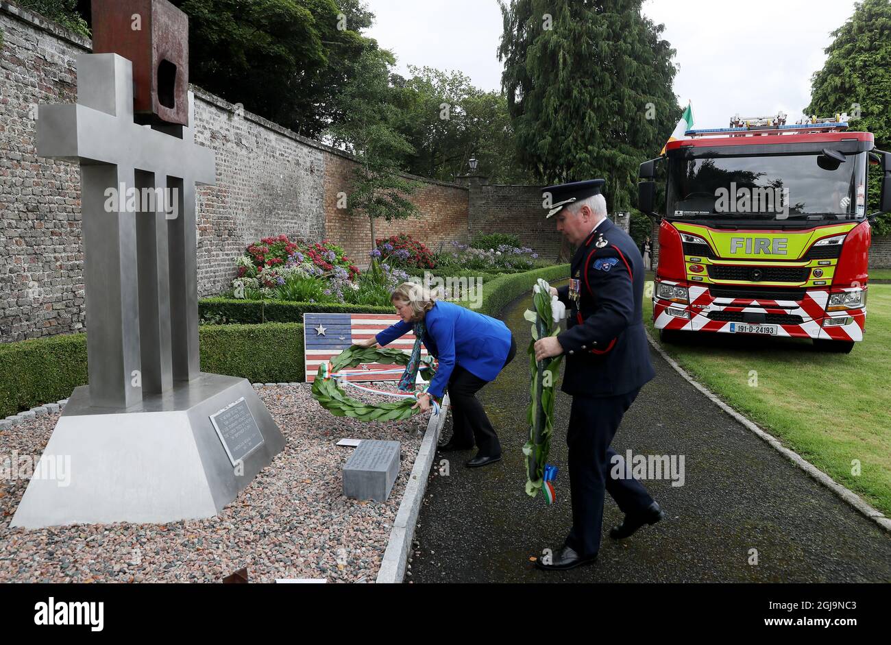Charge d'Affaires Alexandra McNight (left) and Dennis Keeley, acting Chief Officer Dublin Fire Brigade, lay wreaths during a 20th anniversary event at the US Ambassador's Residence in Dublin to commemorate the lives lost during the 9/11 attacks. Picture date: Wednesday August 25, 2021. Stock Photo