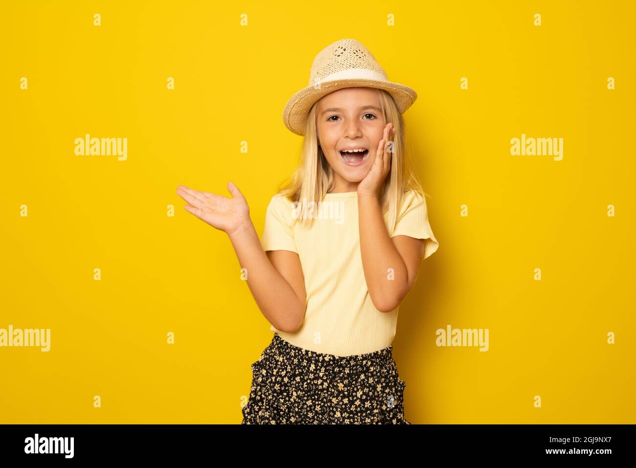 Portrait of cute smiling little girl wearing straw hat isolated over ...