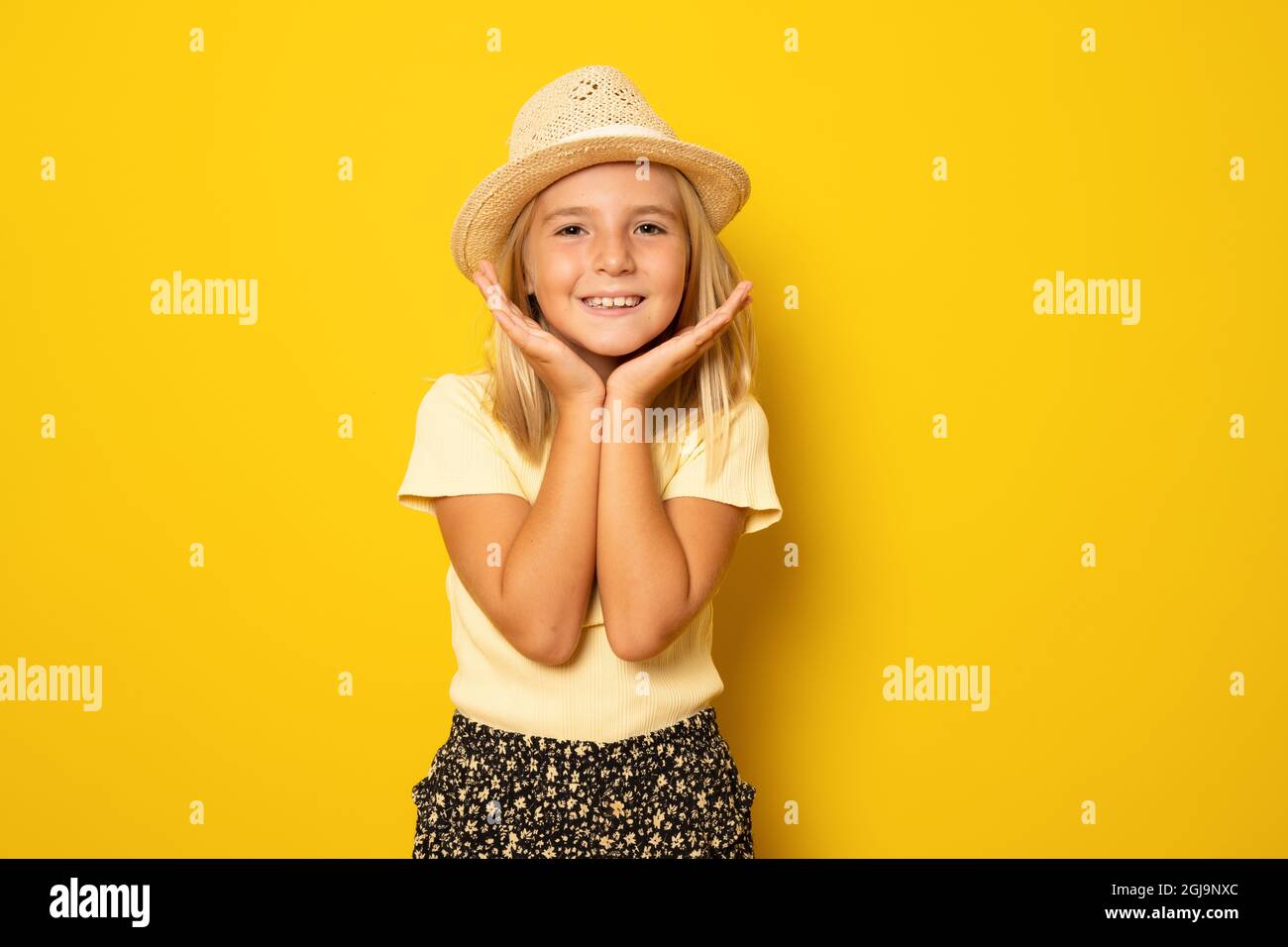 Portrait of cute smiling little girl wearing straw hat isolated over ...